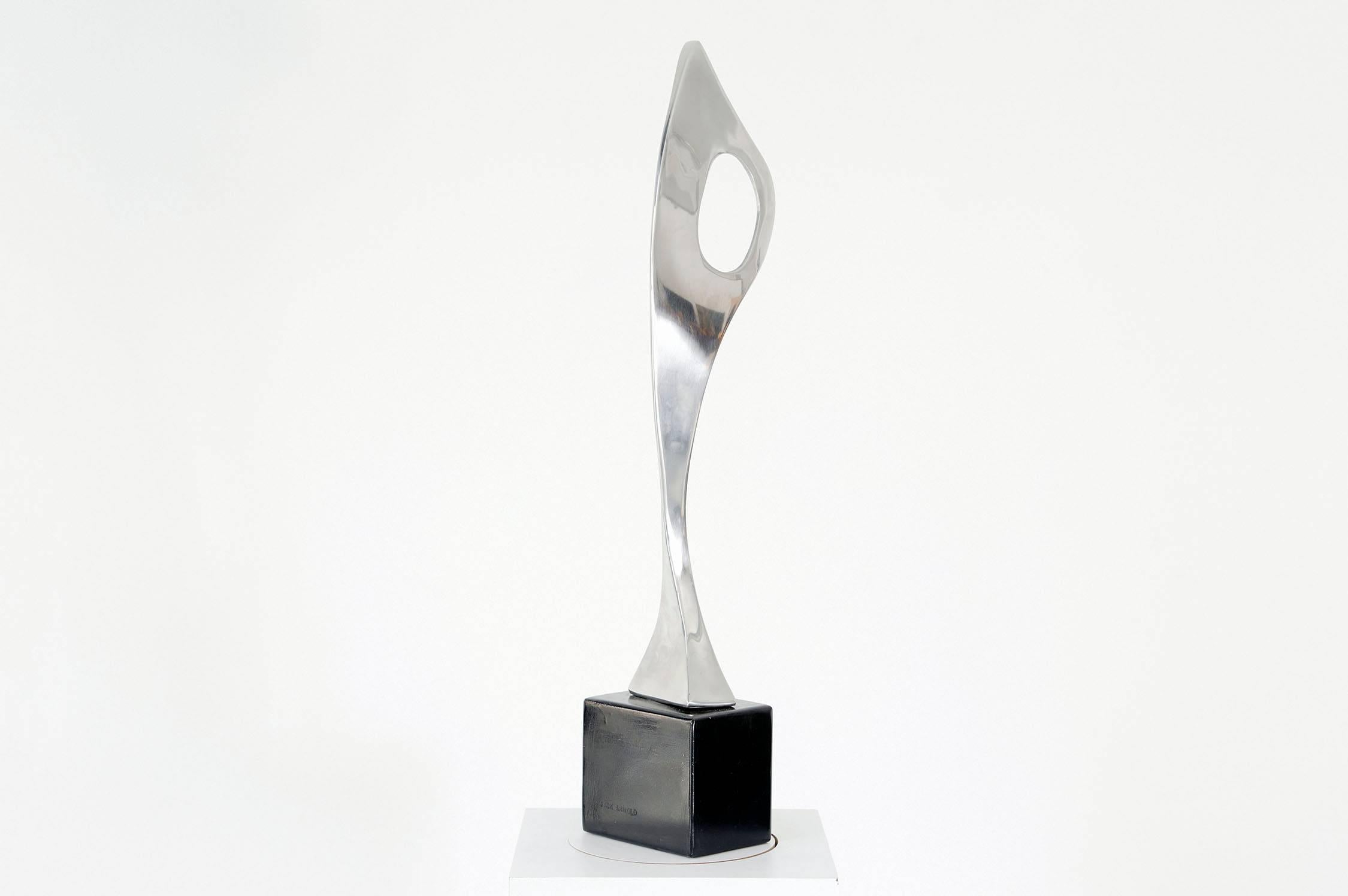 Jack Arnold modernist sculpture. Polished stainless steel modernist form atop a black steel base by renowned artist Jack Arnold. Embossed signature on the base.