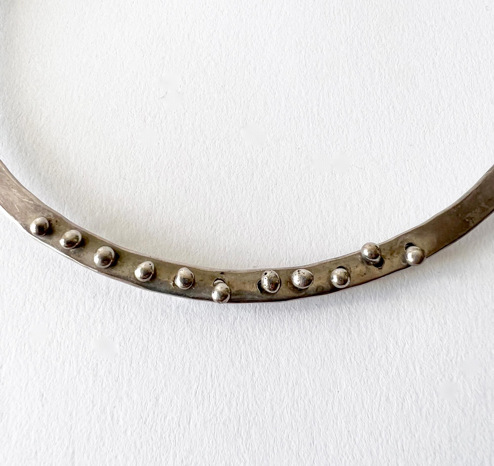 Hand wrought sterling silver torque choker necklace with peg design created by Jack Boyd of San Diego, California.  Necklace measures approximately 17