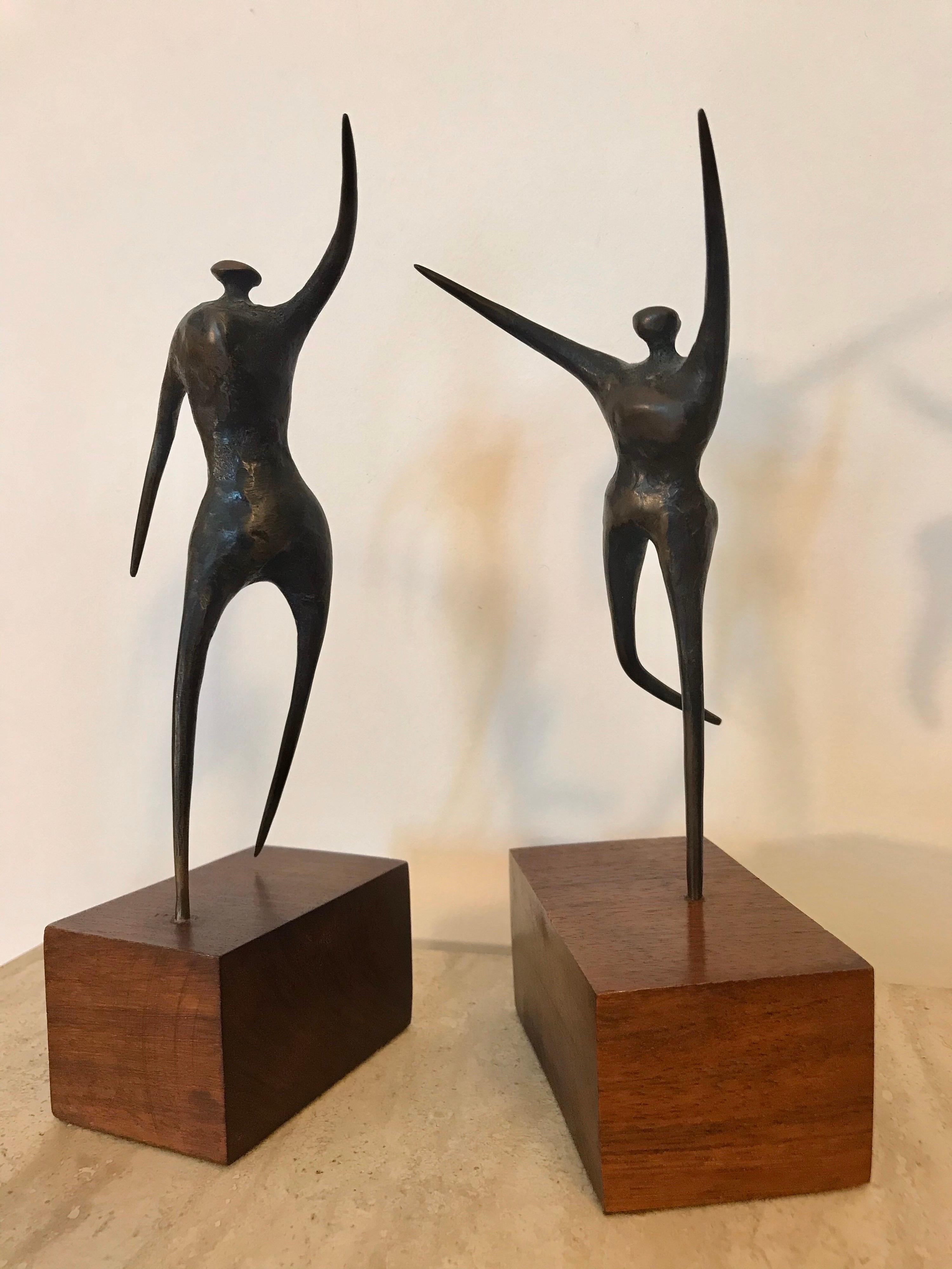 Mr. Boyd was an artist out of San Diego California. 
These pair of sculptures are a fine example of his art.
They appear to be a male and female couple that are floating or dancing effortlessly in the negative space around them. 
The tallest is