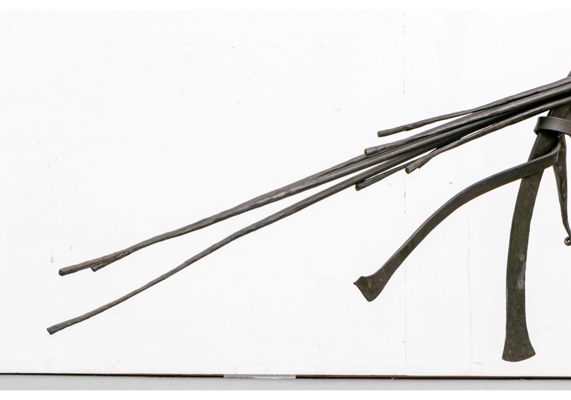 A large, dramatic and very powerful hanging Sculpture by Jack Brubaker (Am., 20th-21st C). Craftsman designed inventive iron fixture with long stemmed Calla Lily flowers bound with a flat iron ribbon in the middle. The eight separate candle socket