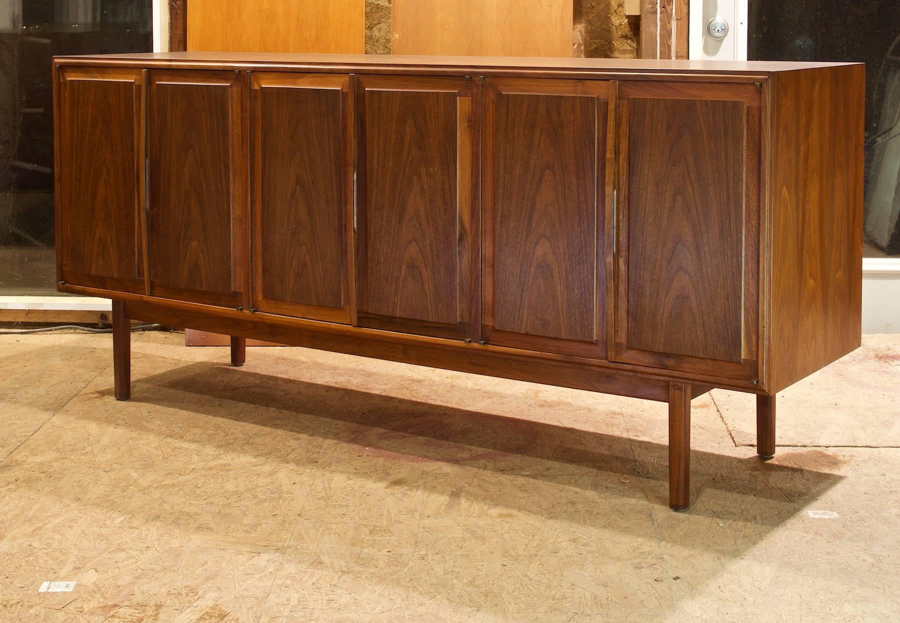 Attributed to Milo Baughman for FOUNDERS, this casegood is unmarked.

Wonderful High End Quality; all solid oil finished walnut, warm active grain throughout the six doors and case. Three interior drawers and three interior adjustable shelves. Top