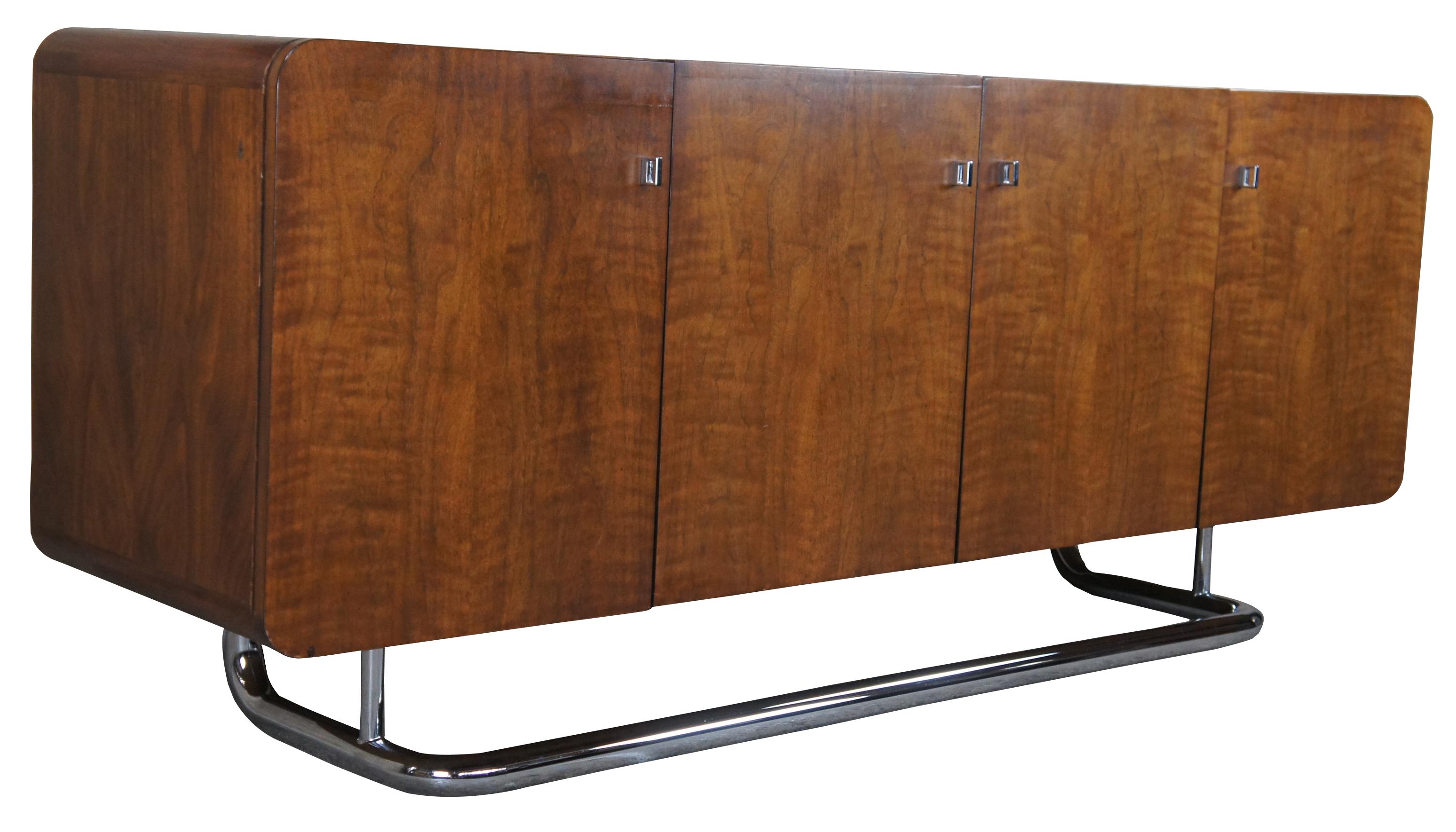 1970s Vintage Buffet, credenza or sideboard by Jack Cartwright for Founders Furniture. The carefully chosen American walnut veneers compliment the sleek tubular chrome base. Interior storage includes three center drawers flanked by adjustable