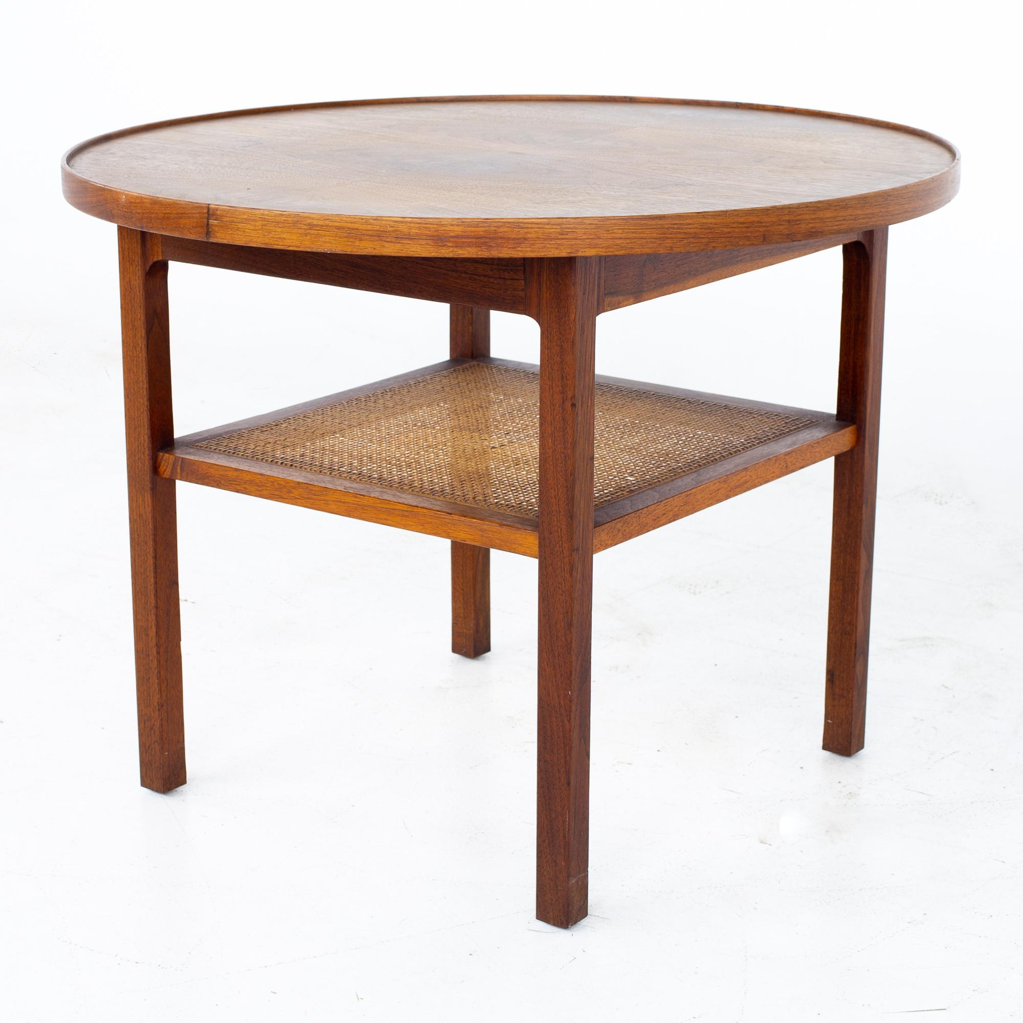 Jack Cartwright for Founders Mid Century Round Side End Table with Cane Shelf
Table measures: 27 wide x 27 deep x 20.5 inches high

All pieces of furniture can be had in what we call restored vintage condition. That means the piece is restored upon