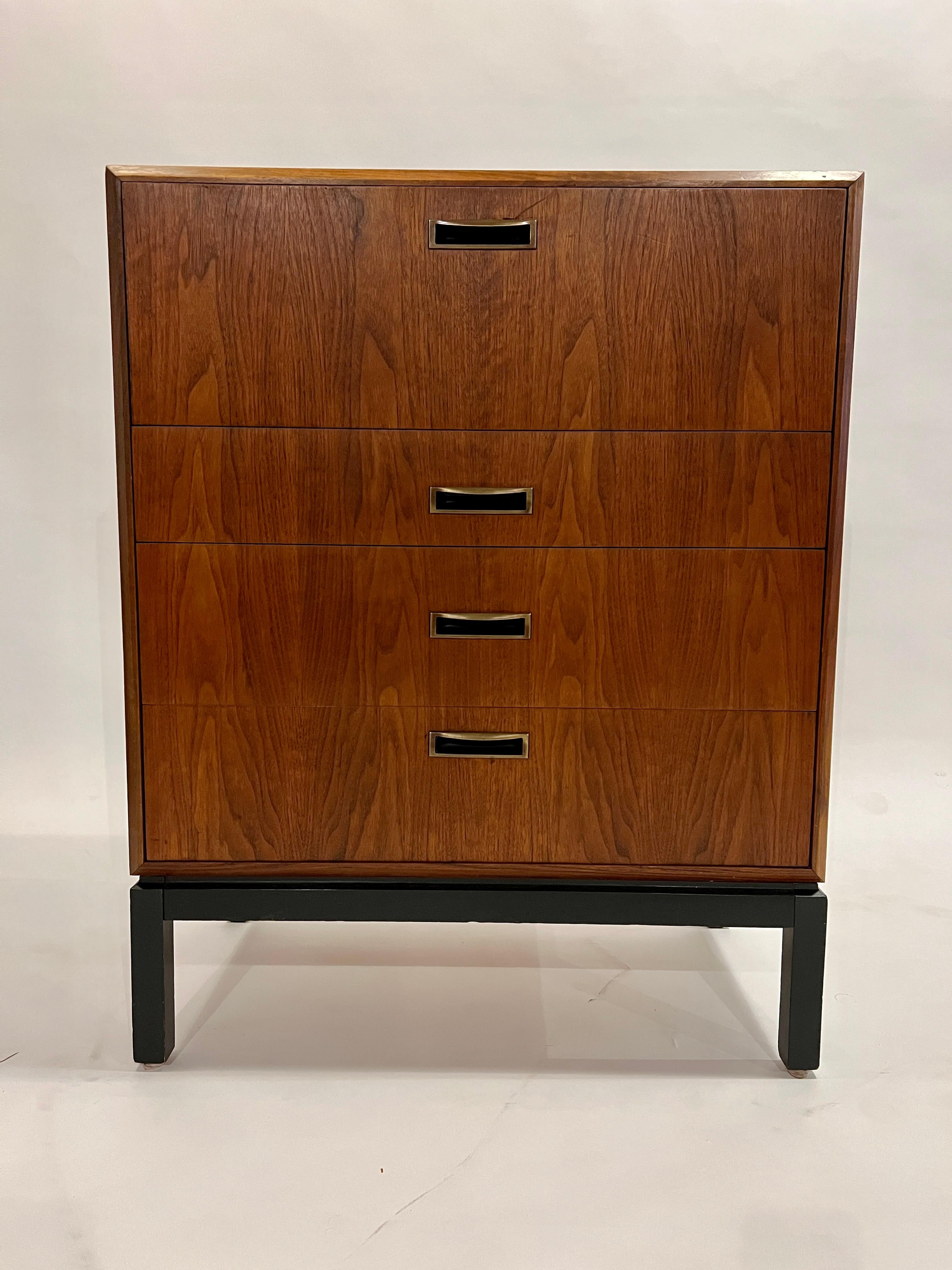 Midcentury walnut tall dresser with a pullout secretary and three lower drawers designed by Jack Cartwright for Founders Furniture Co. This highly functional and truly versatile case good can be used in a variety of spaces including a bedroom,