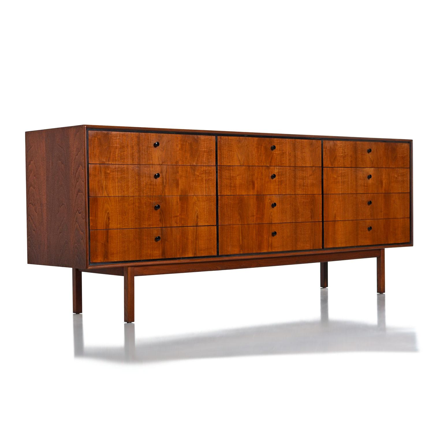 Mid-Century Modern walnut dresser. Manufactured by Founders Furniture and designed by Jack Cartwright, circa 1960s. Sleek, elegant, minimalist design made with the finest quality materials. Crafted with a mix of old growth, solid walnut, solid