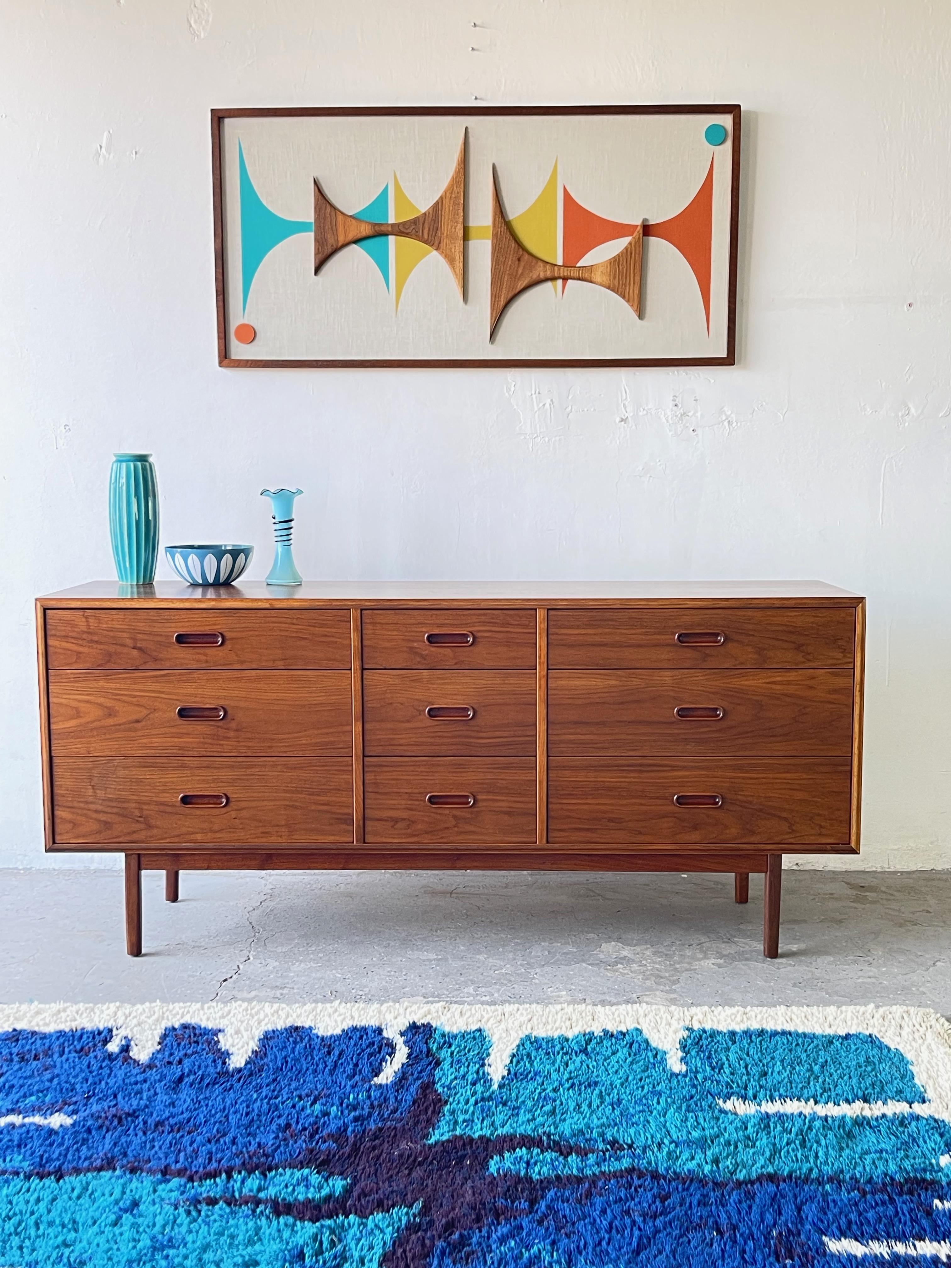 Walnut low boy dresser by Founders. Designed by Jack Cartwright, this fantastic walnut dresser, has nine drawers and a beautiful walnut finish. Use in front hall as a landing strip for your keys, mail, etc. or in the bedroom as a dresser or as a