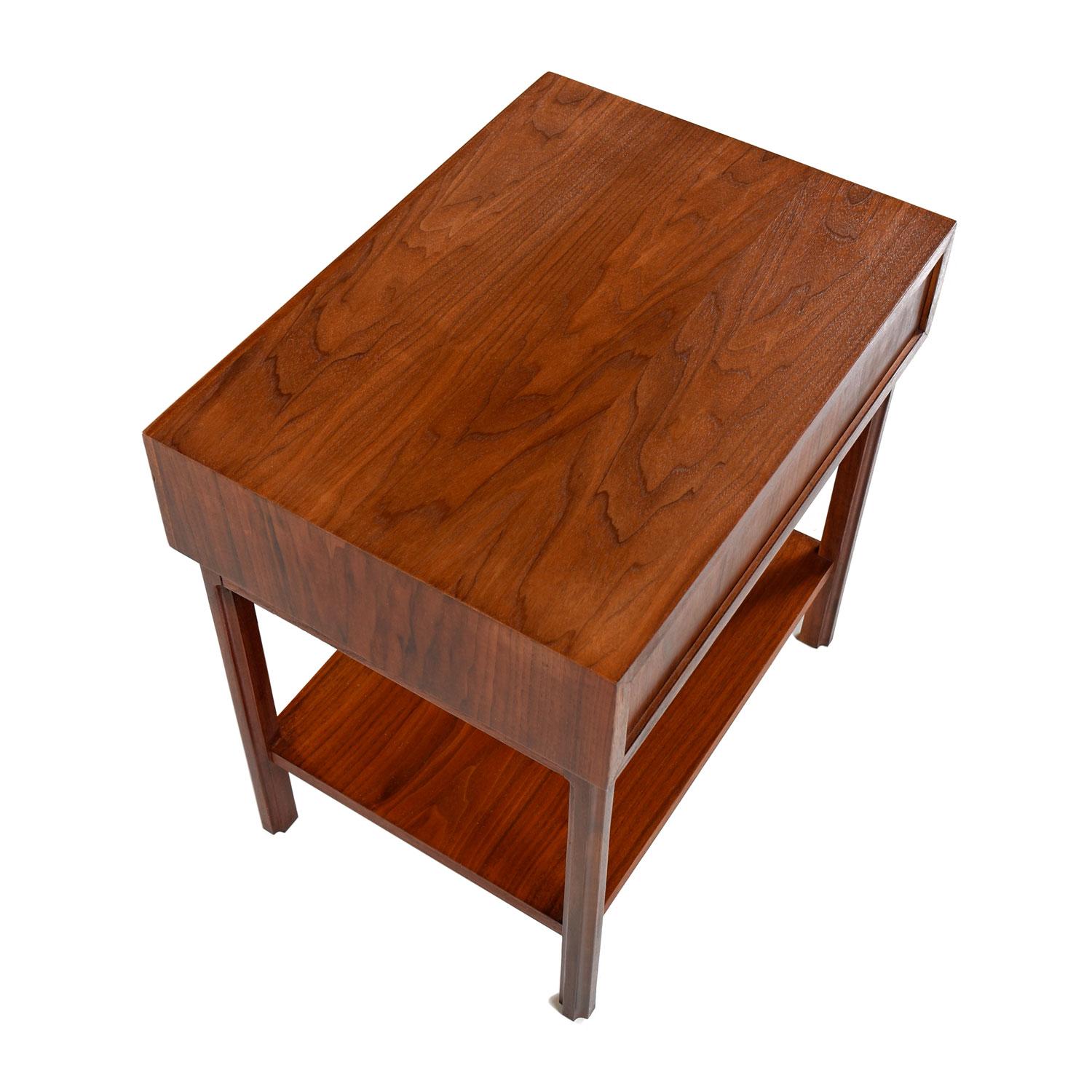 Mid-Century Modern walnut bedside table nightstand. Manufactured by Founders Furniture and designed by Jack Cartwright, circa 1960s. Sleek, elegant, Minimalist design made with the finest quality materials. Crafted with a mix of old growth, solid