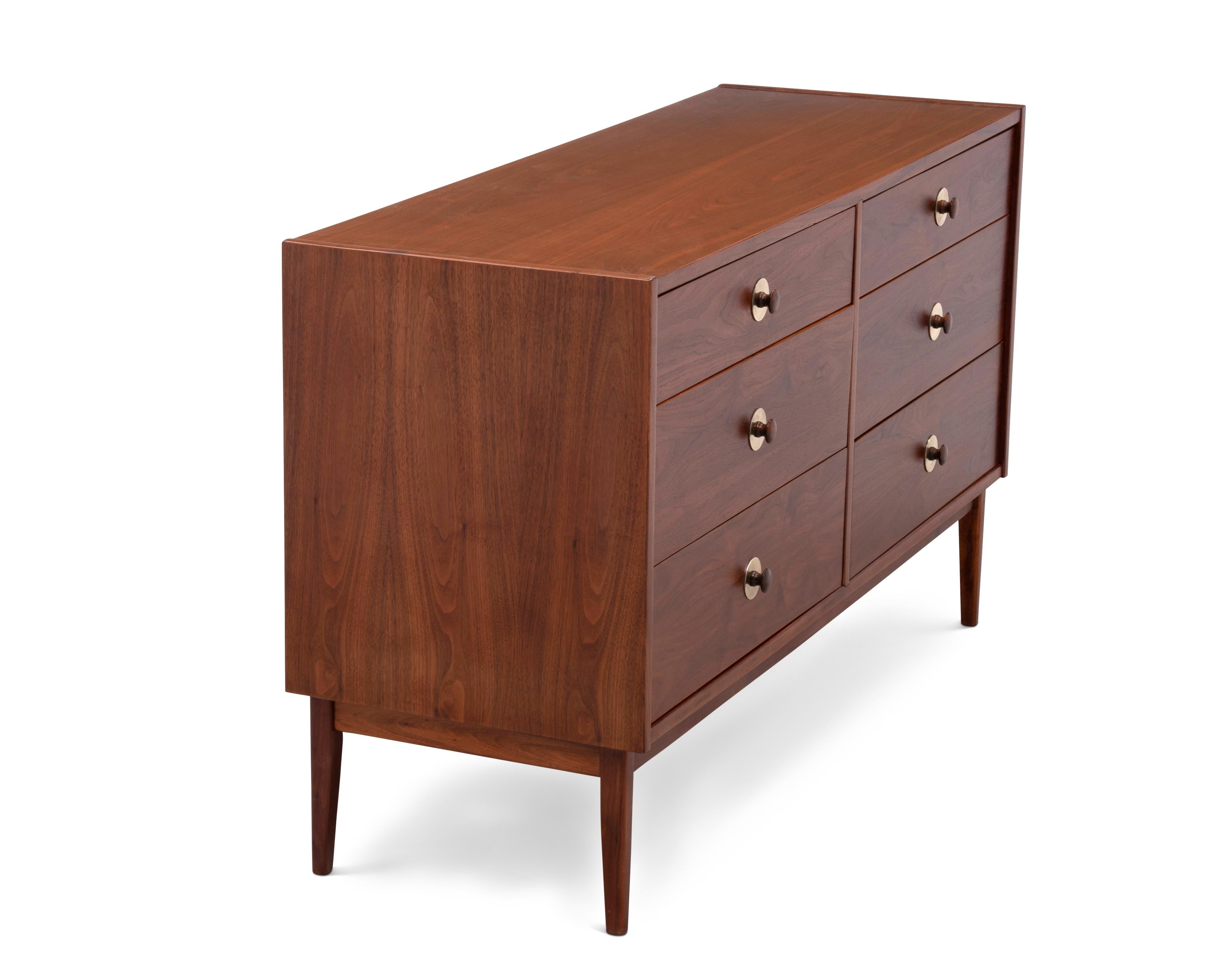 An elegant and very well made Mid-Century Modern six drawer lowboy dresser designed by Jack Cartwright for Founders Furniture. Walnut case with walnut and brass hardware. Unmarked.