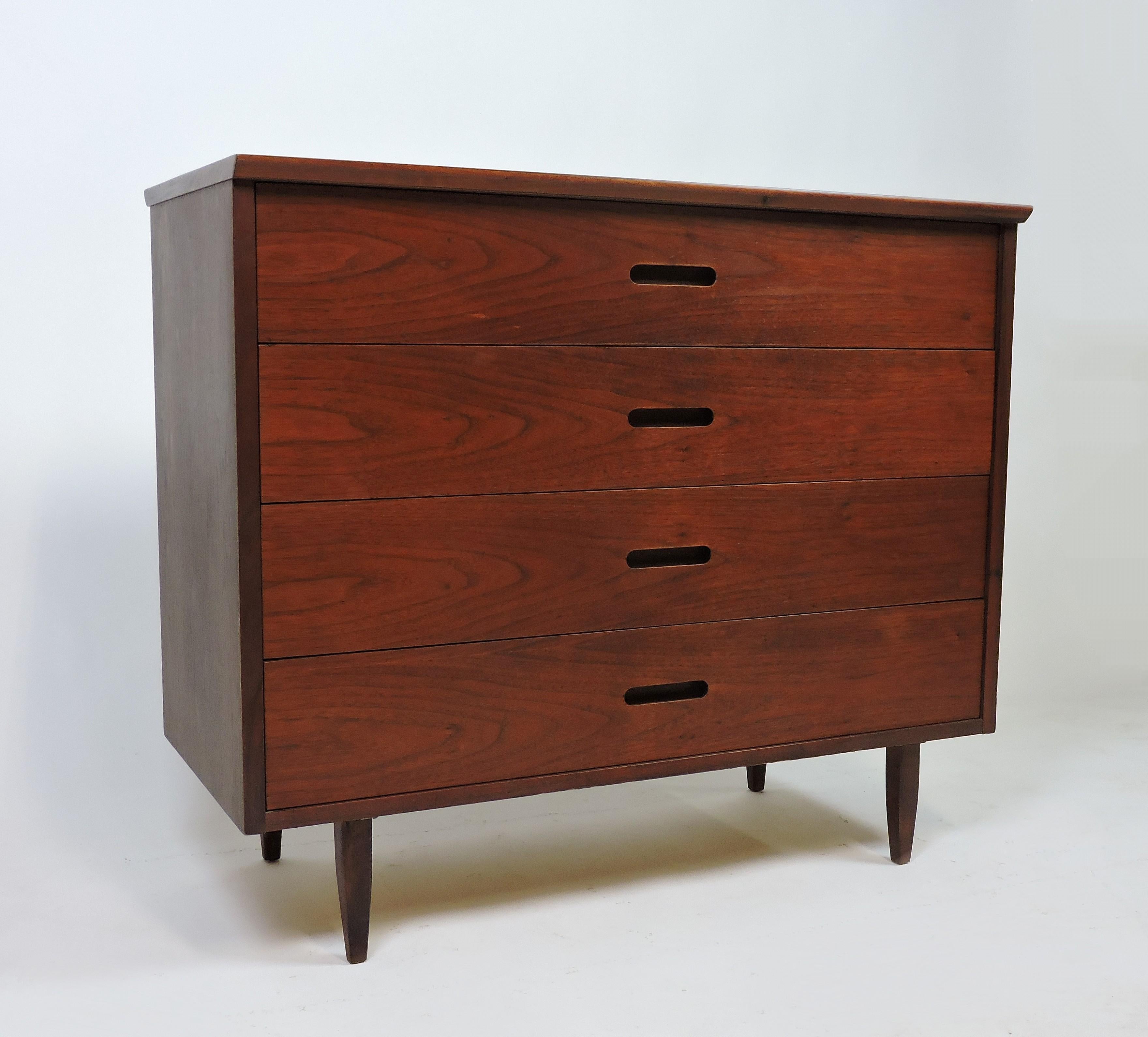 Handsome walnut dresser designed by Jack Cartwright and manufactured by Founders Furniture Company. This cabinet has beautiful wood grain and four drawers with Minimalist Scandinavian style inset pulls.


   