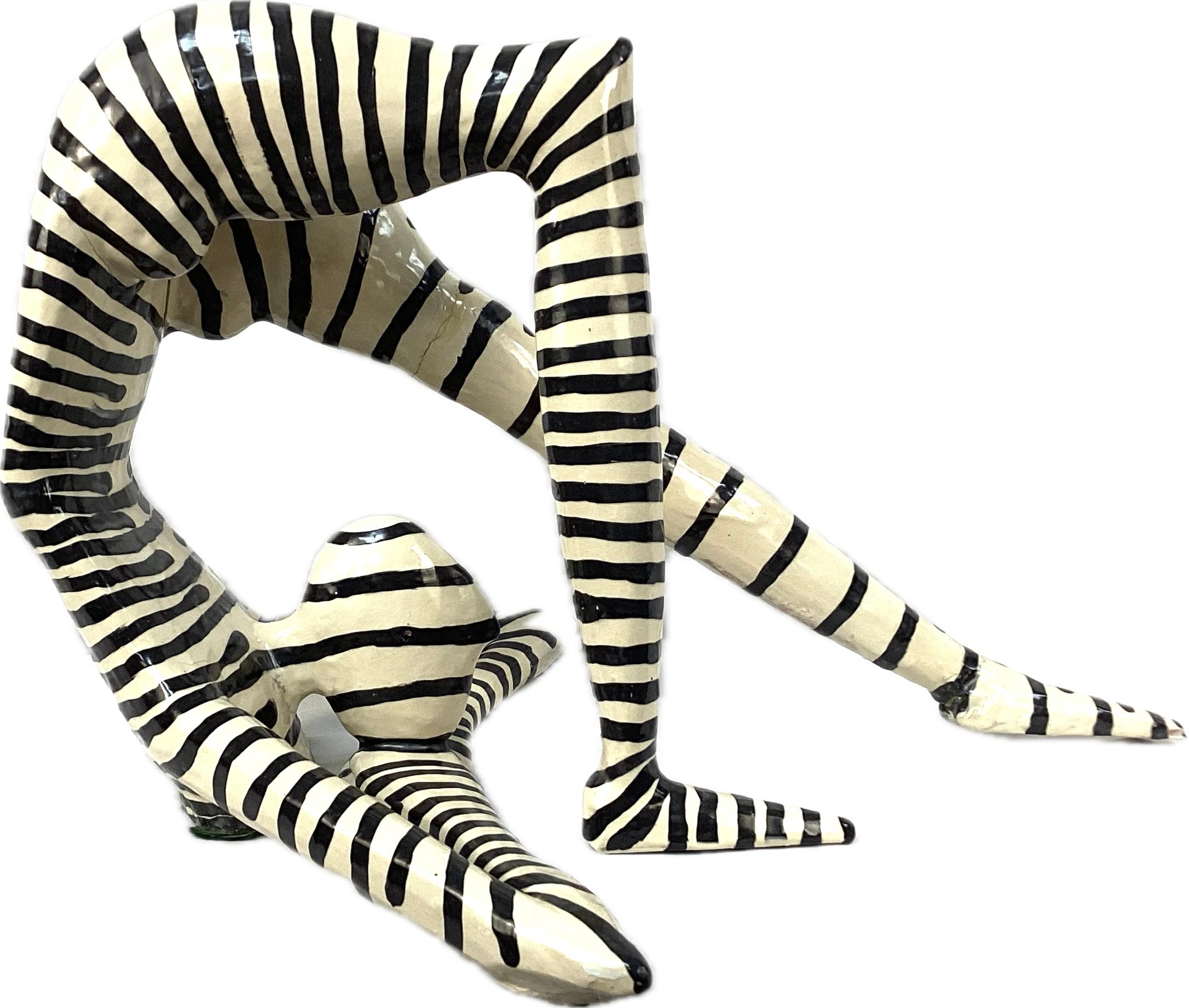 Jack Charney Black and White Striped Acrobatic Sculpture. Charney
(1927-2014) was an American artist best known for his work in ceramics, particularly for creating abstract sculptures that evoke a sense of dynamics, fluidity, and organic form. This