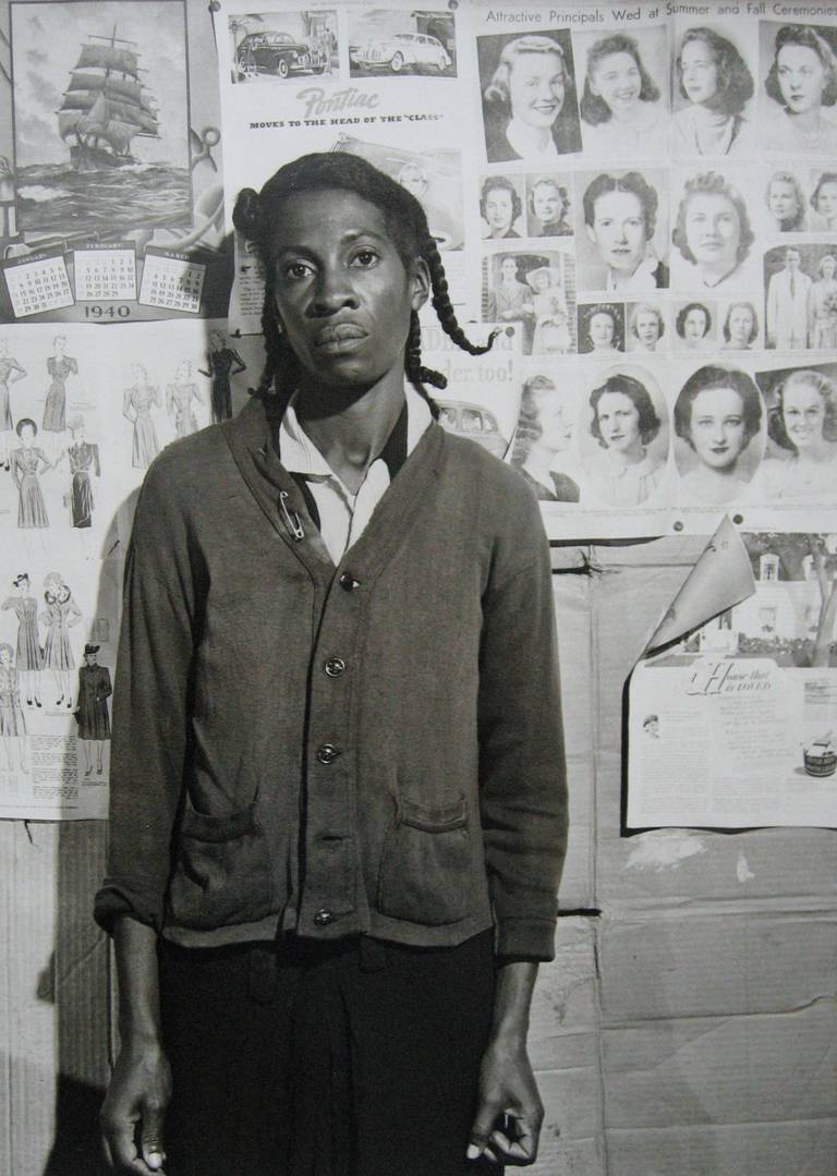 Jack Delano Portrait Photograph - Untitled (Woman in front of Wall of Hairstyles)