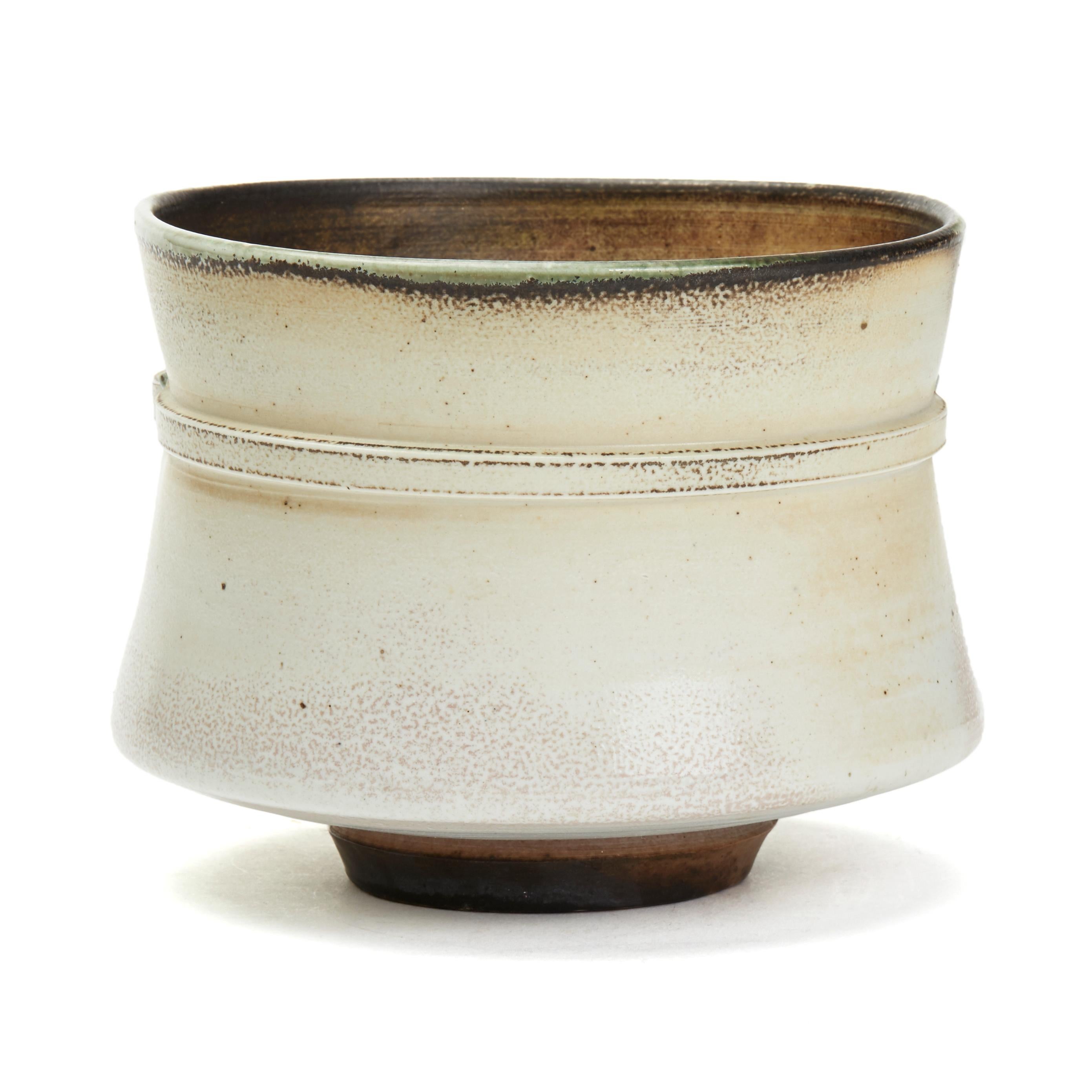 A stylish Studio Pottery porcelain strapped and pinched vessel wide rounded form by renowned Irish potter Jack Doherty (b. 1948). The rounded cylindrical shaped vessel has a moulded strap applied around the upper body with two 'impressed' studs to
