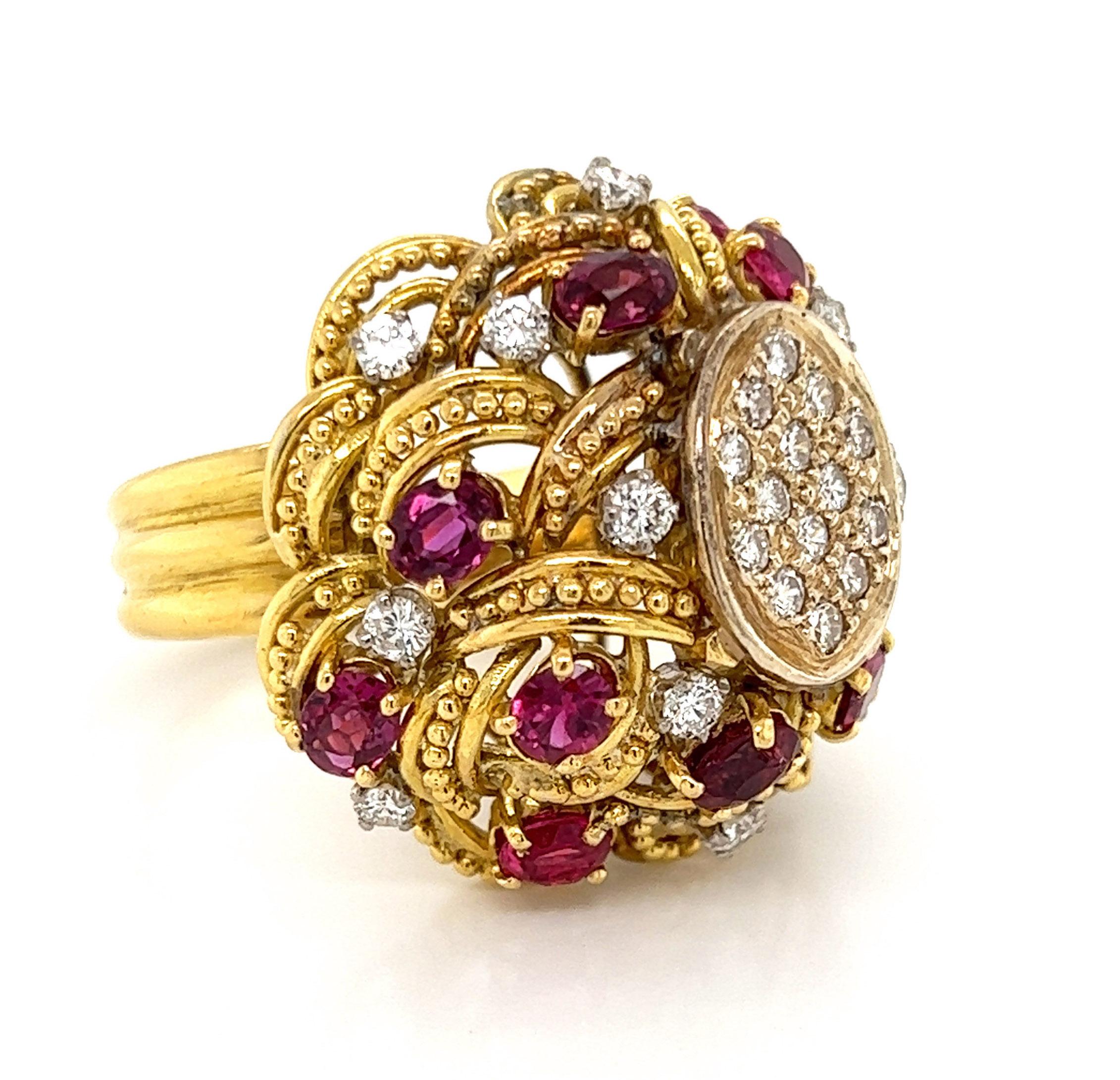 This particular ring is crafted from 18k yellow gold with a large dome shape fashioned from layered lace like pattern with small beads across each loop and has small open space between each layer. Around the dome has round cut rubies in yellow gold