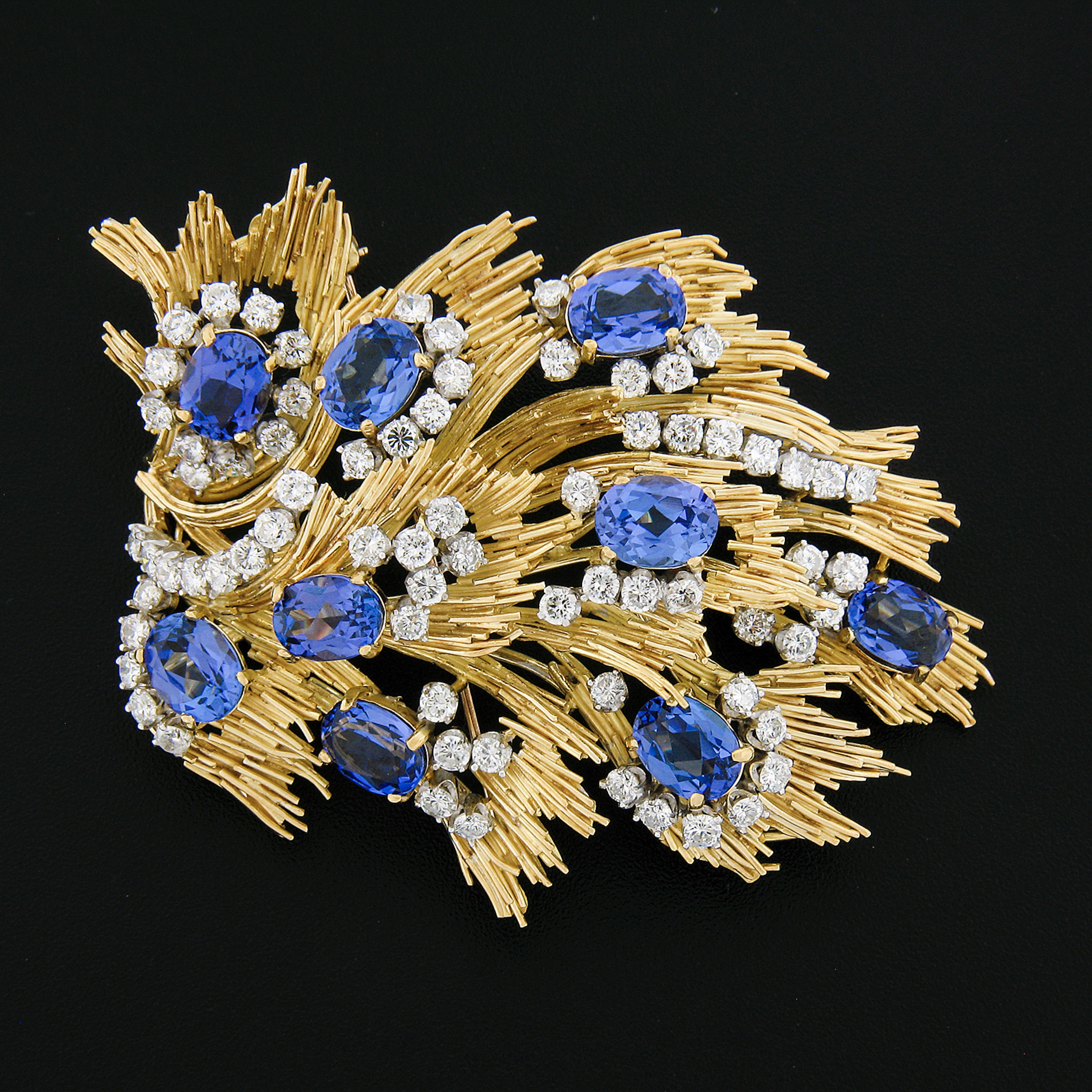 Here we have a stunning, vintage Jack Gutschneider statement brooch hand crafted in solid 18k yellow gold and adorned with the most amazing quality natural tanzanite and diamonds throughout the super unique flames design. Each of the oval tanzanite