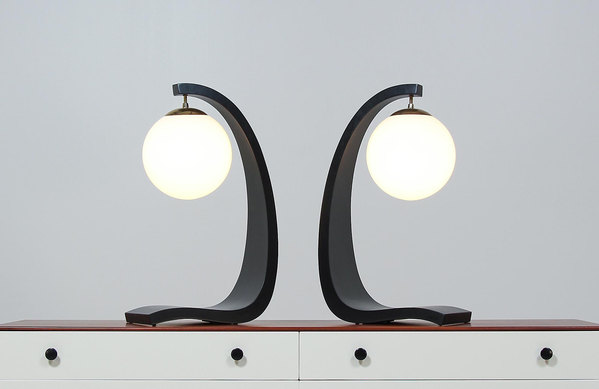 Beautiful pair of Mid-Century Modern table lamps designed by architect and designer Jack Haywood for Modeline of California in the United States circa 1960s. This dazzling lighting design features smooth curves that create a tall sculptural body