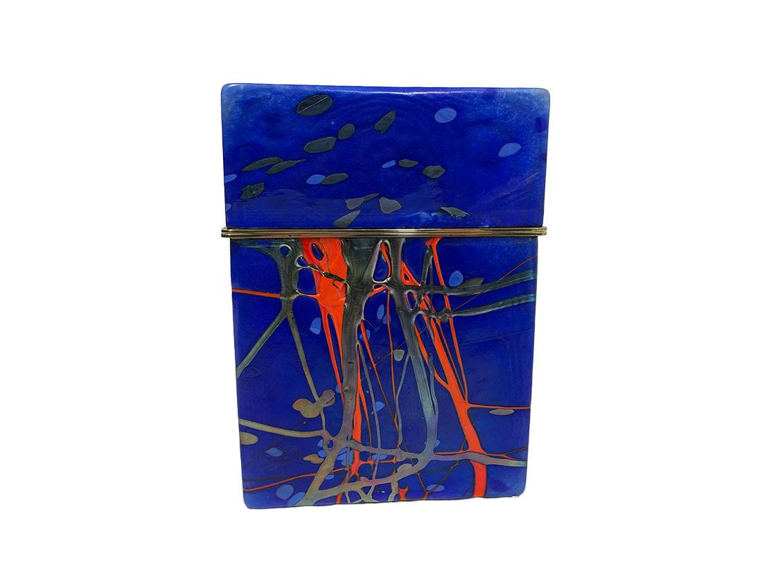 Jack Ink Art glass box, 1980s

A rectangular Art Glass box, with the main color of blue and consisting of 2 parts with brass. Light makes the art iridescent. The scene has the impression of expressionist thick layers of paint with the colors