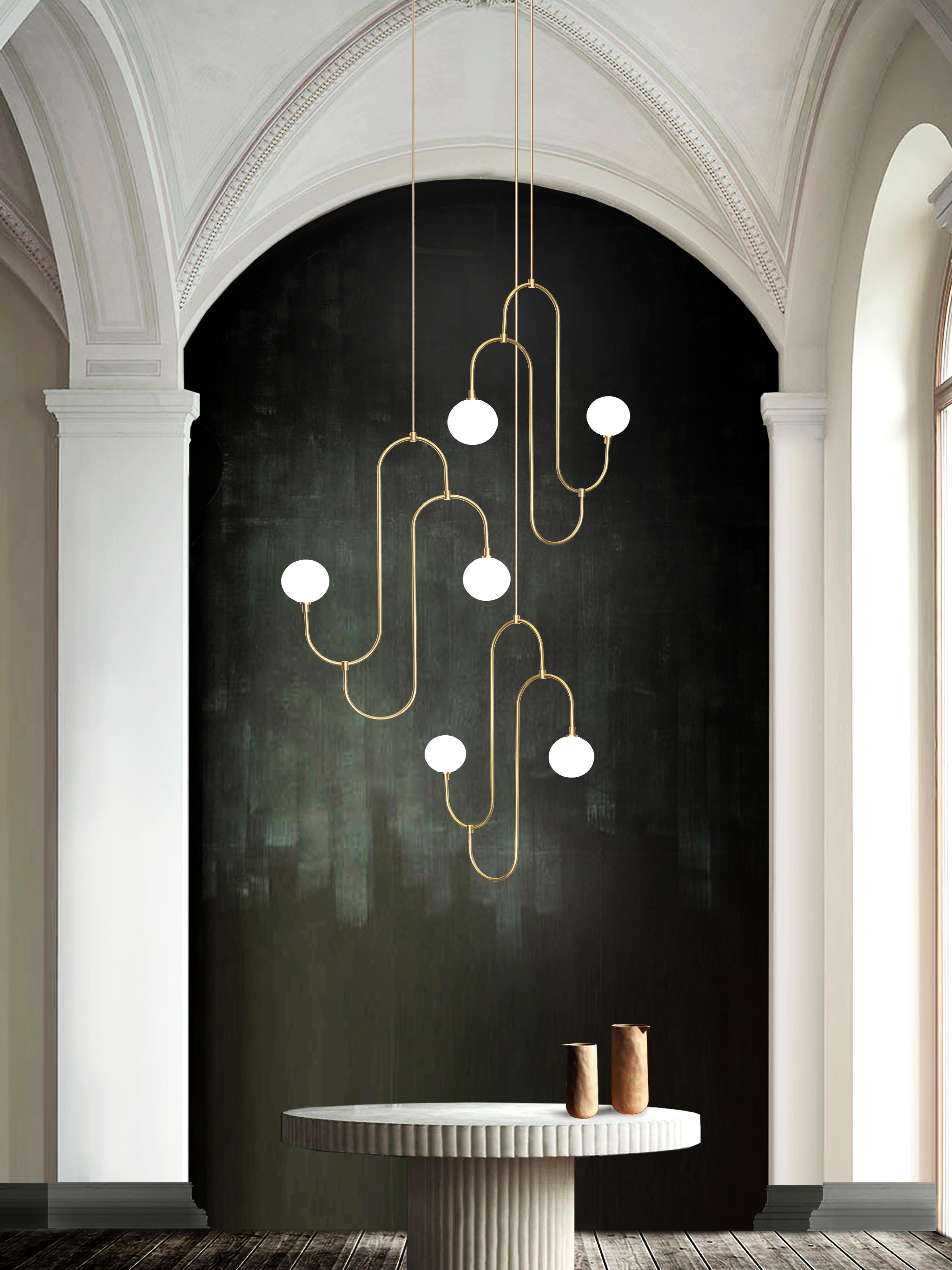 Inspired by the repeated patterns and sculptural form of 1930s jewelry design. The pendant incorporates hand bent brass arms that hold pearl white crystal glass, creating a decorative, functional lighting feature. 

G12 LED bulb
Lumens: