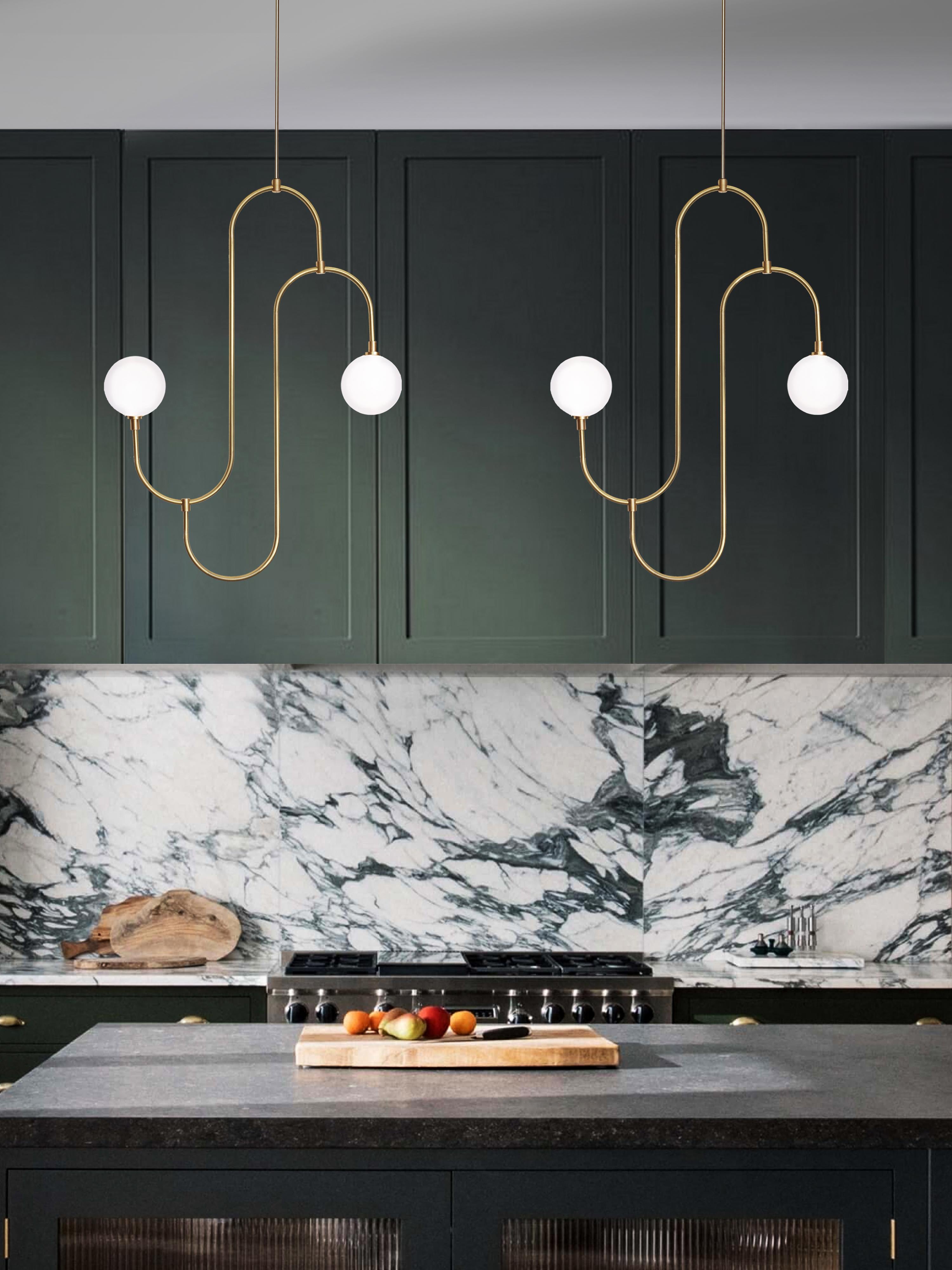 Inspired by the repeated patterns and sculptural form of 1930s jewelry design. The pendant incorporates hand bent brass arms that hold pearl white crystal glass, creating a decorative, functional lighting feature. 

G12 LED bulb
Lumens: