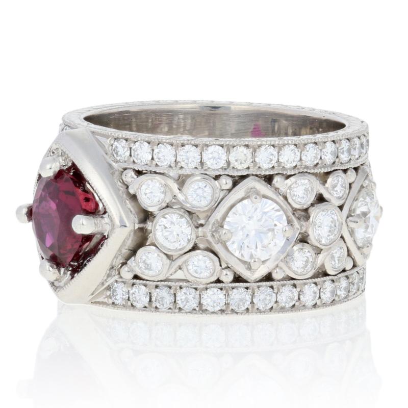 This ring is a size 5 1/2.

Brand: Jack Kelége

Metal Content: Guaranteed 900 Platinum as stamped

Stone Information: 
Genuine Ruby
Treatment: Heating 
Color: Red
Cut: Round 
Size (mm): 6.12 - 5.98 x 3.54 
Carat: 1.16ct

Natural Diamonds  
Clarity: