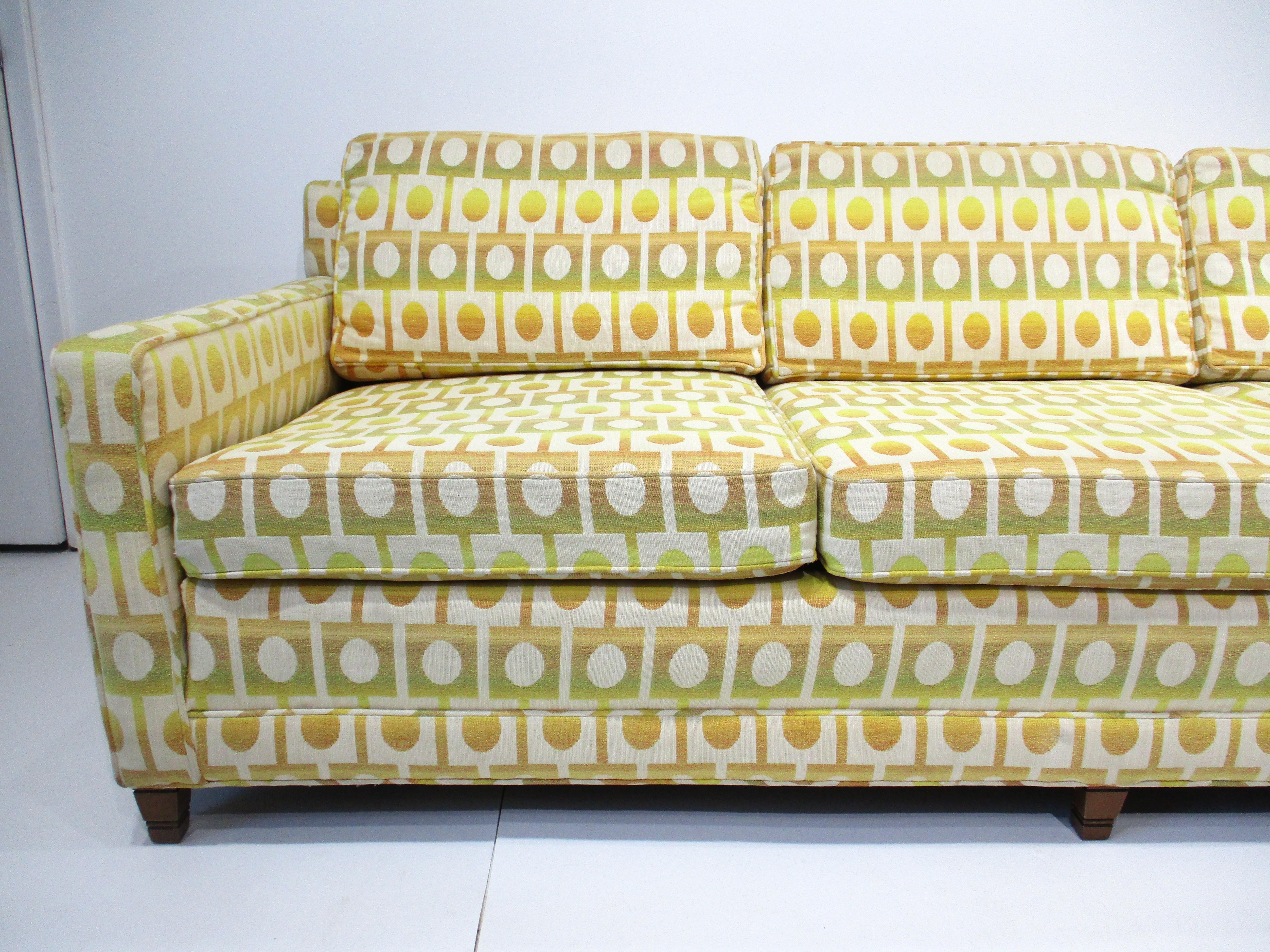 A exceptional stunning Mid Century sofa upholstered in Jack Lenor Larsen styled fabric known for it's unique designs and colors . This well crafted sofa was manufactured by the Henredon furniture company and includes the original arm cover all in