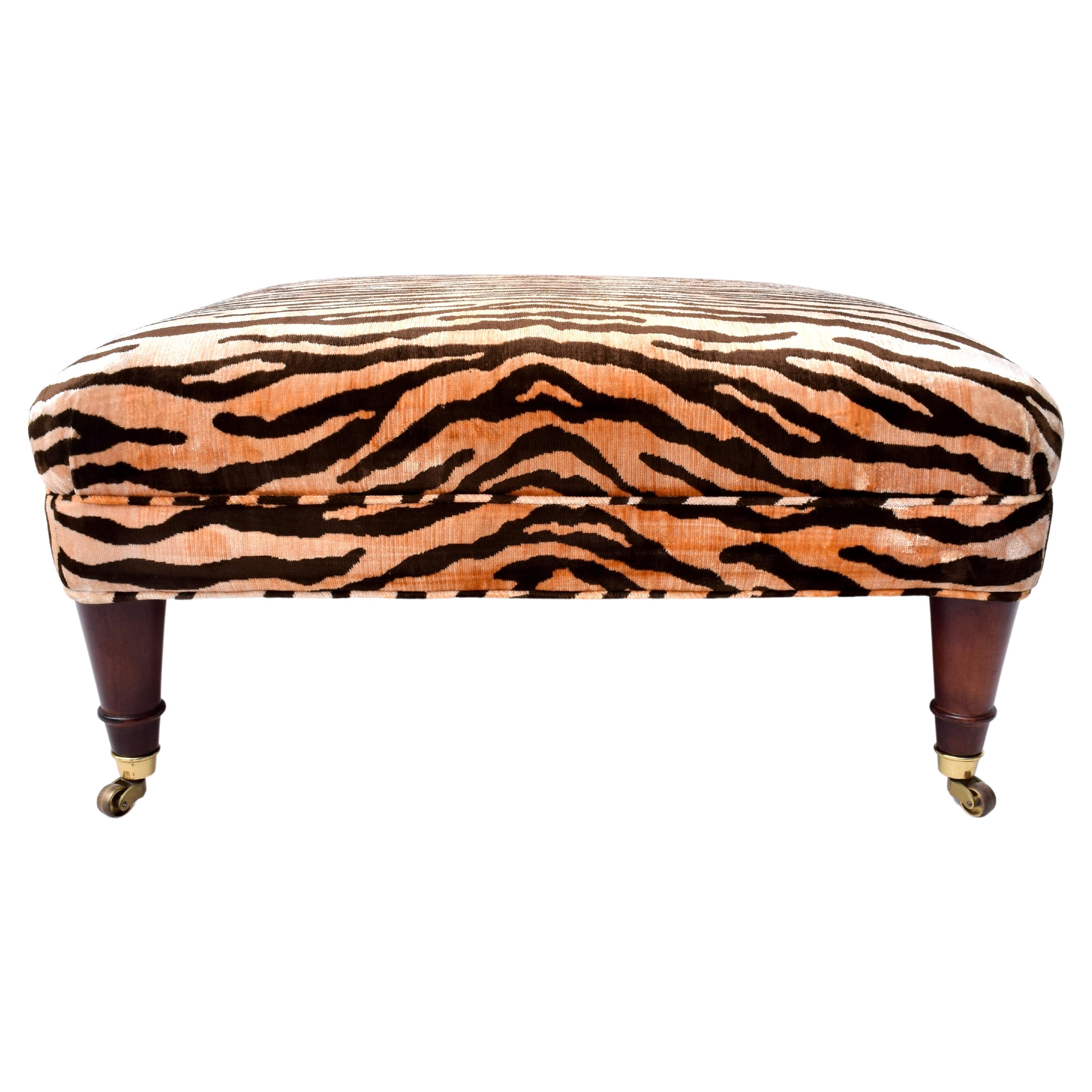 Mid century ottoman in Tigre velvet with turned Mahogany legs on brass casters by Jack Lenore Larsen Inc. Larsen Furniture; founded 1952.  Scarcely seen 20th c. furniture in beautifully maintained all original condition.