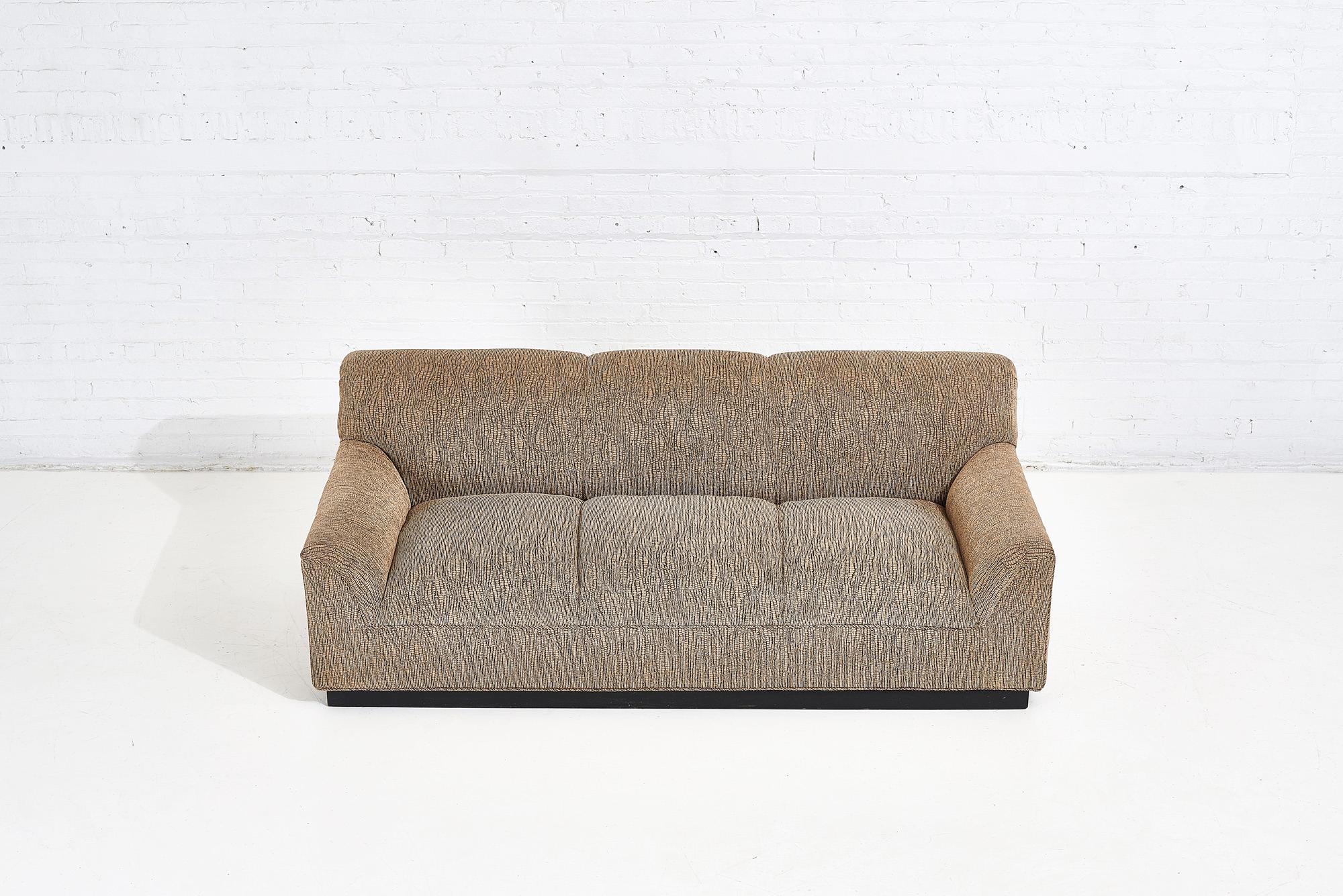 1970 sofa upholstered in Jack Lenor Larson fabric. Original with black plinth base.