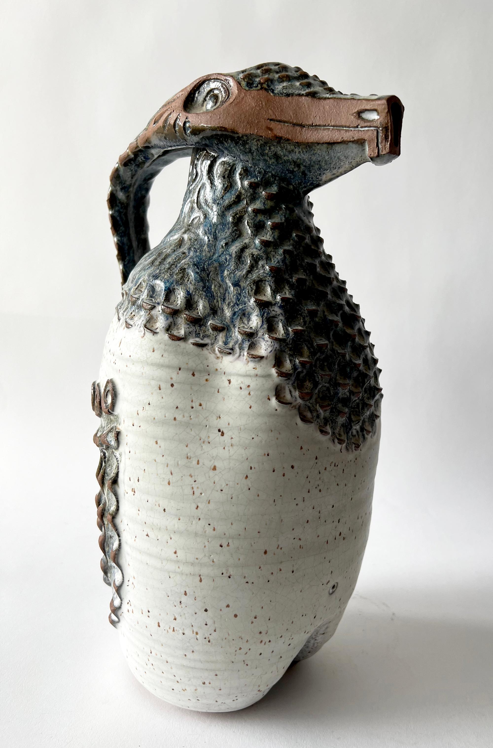Stoneware ceramic reptilian pitcher created by Jack Mason of Stone Mountain, Georgia. Pitcher measures 14.5