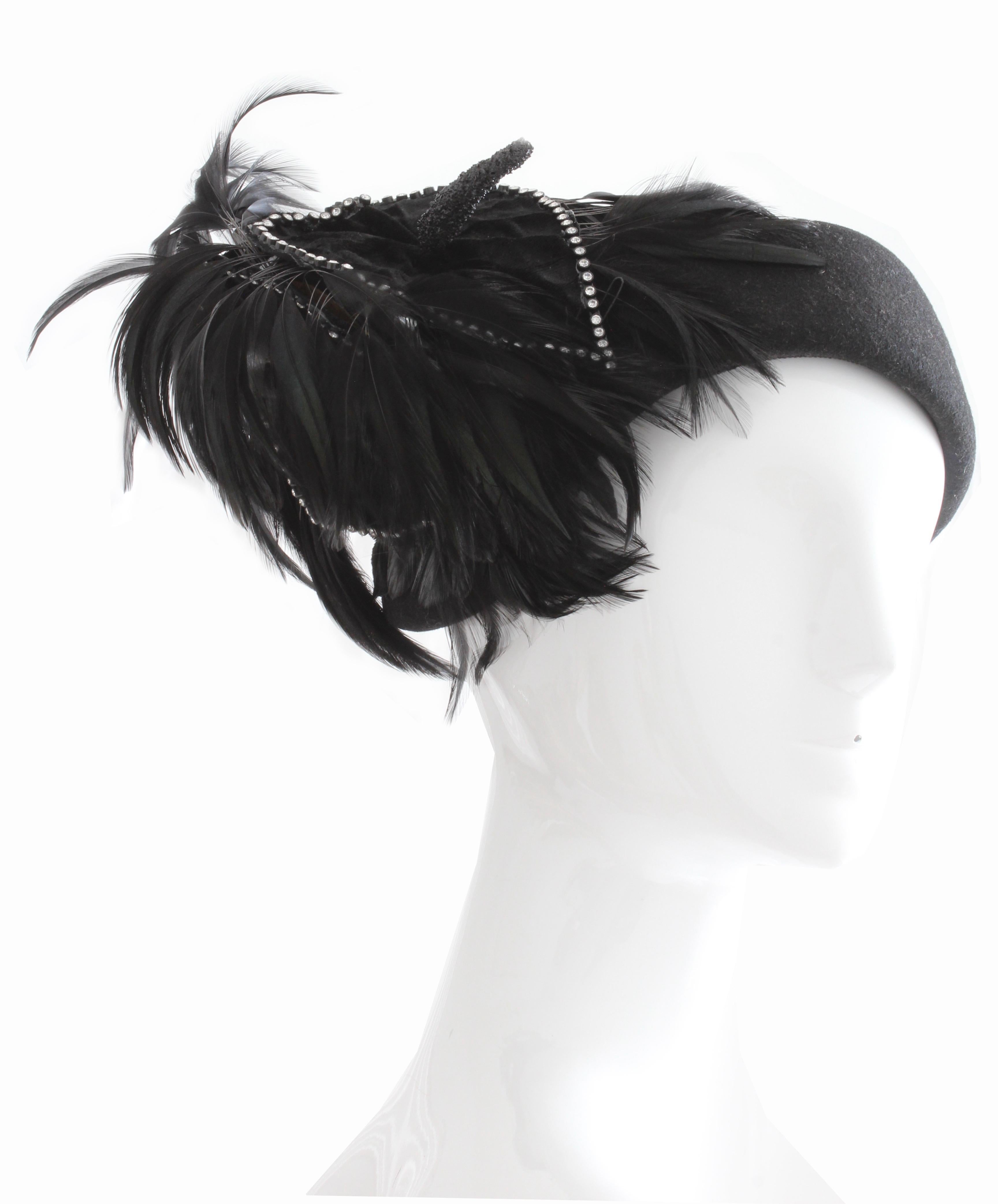 This gorgeous black wool hat with feathers was made by Bollman Hat Co and Jack McConnell Boutique, most likely in the early 60s.  Made from black wool, this piece features a decorative velvet covered floral piece that's outlined in rhinestones with