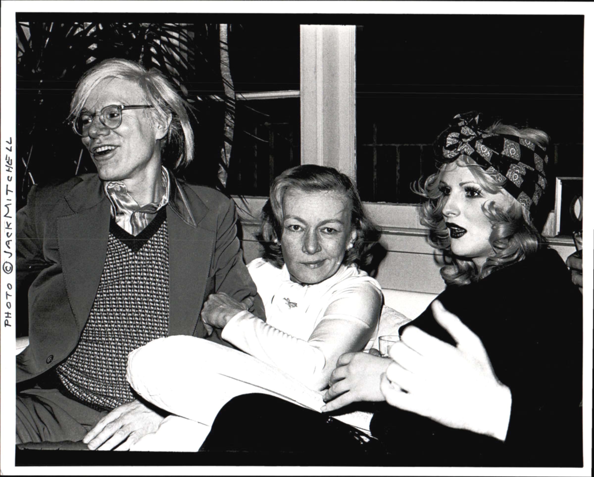 Jack Mitchell Black and White Photograph - Andy Warhol, noir film star Veronica Lake & Candy Darling at a cocktail party