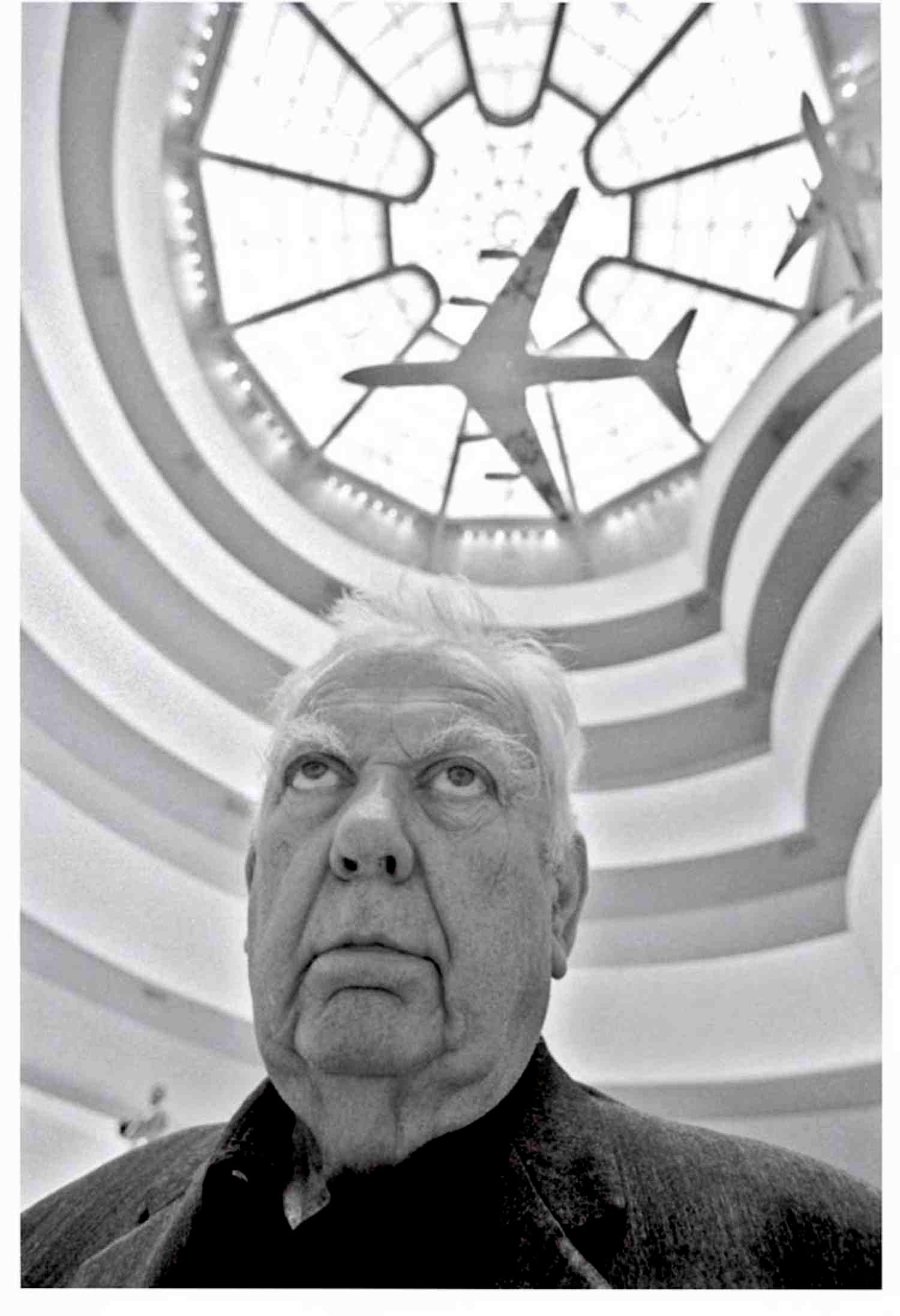 Jack Mitchell Black and White Photograph - Artist Alexander Calder in the Guggenheim gazing up at his painted jet aircraft 