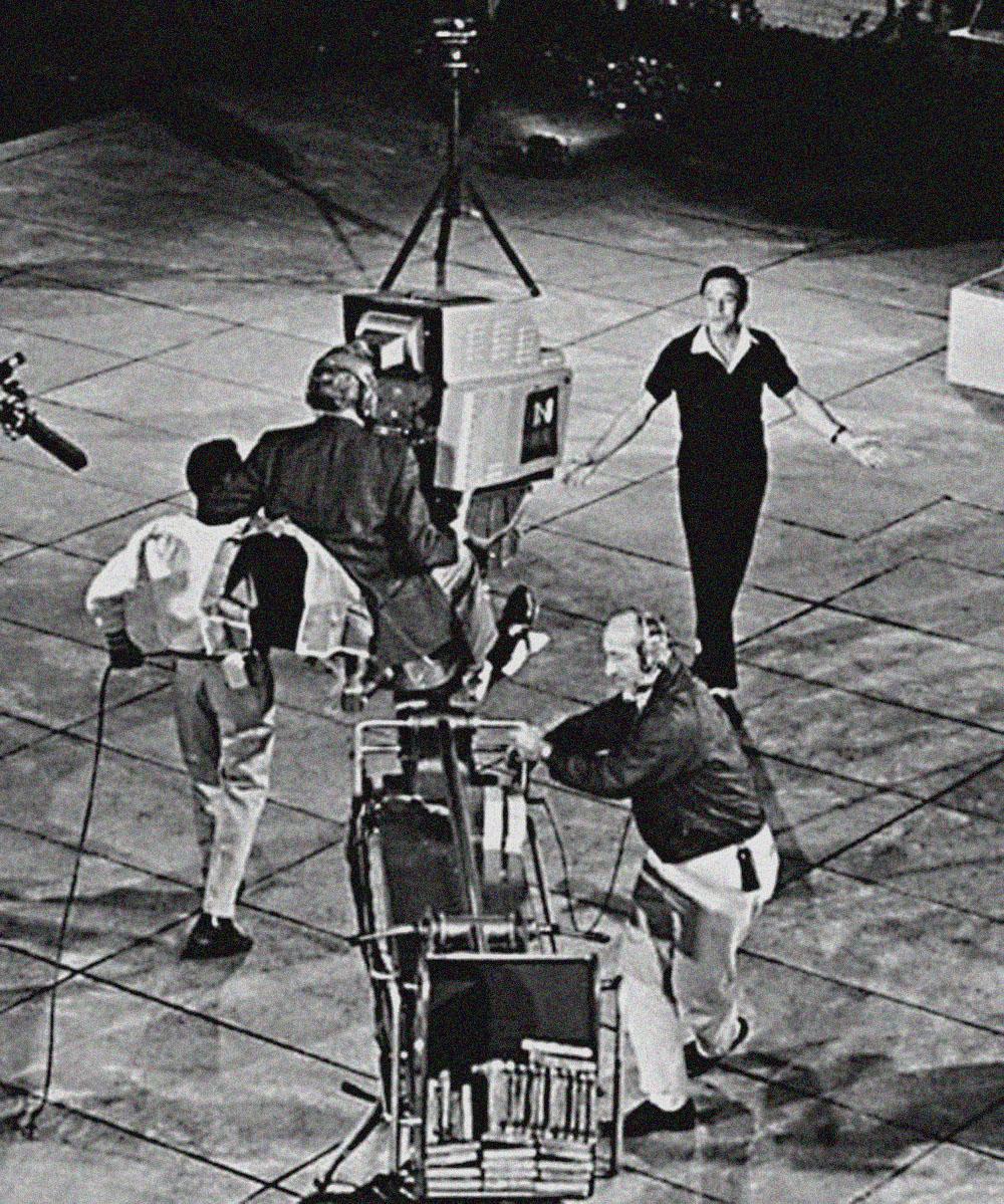 Gene Kelly taping CBS Television special 'New York, NY' in MOMA sculpture garden - Photograph by Jack Mitchell