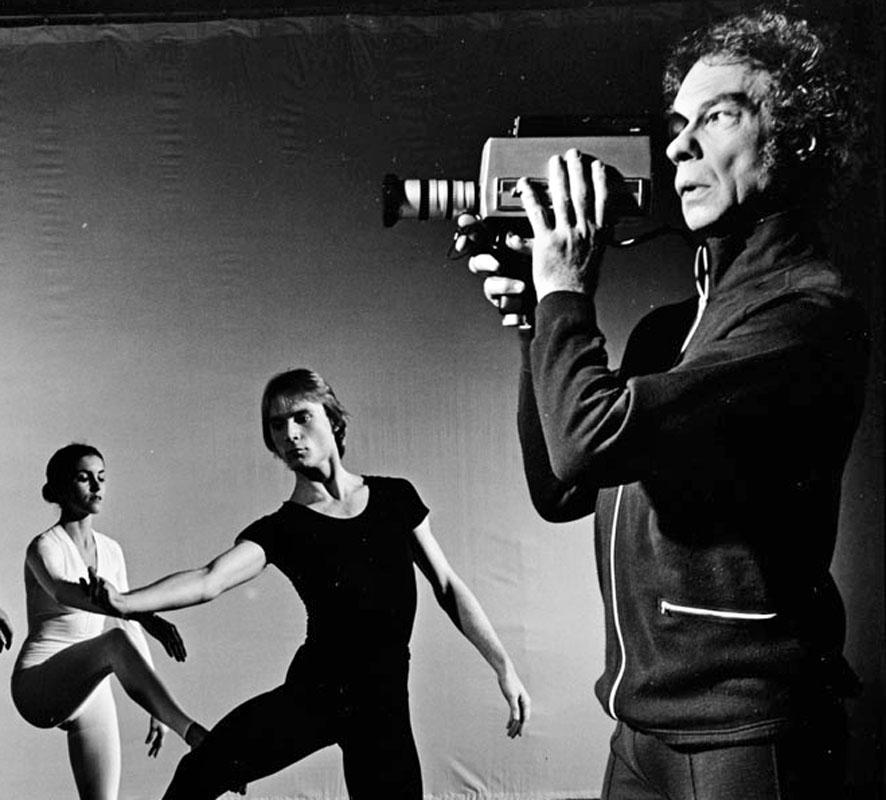 Merce Cunningham with dancers and video camera performing 'TV Rerun' - Photograph by Jack Mitchell