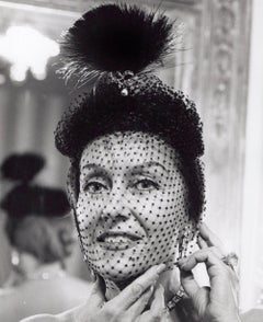 Stage and Screen Star Gloria Swanson posing in the foyer of her NYC home