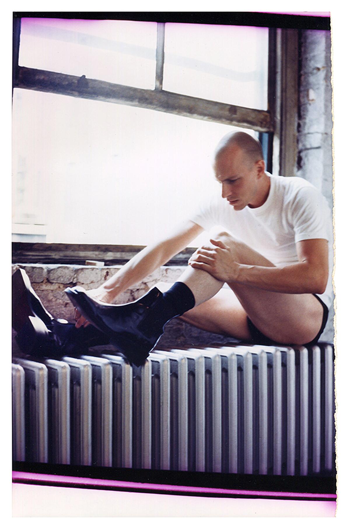 Untitled (Russ C. on Radiator with Boots/Matsuda Shoot) - Photograph by Jack Pierson