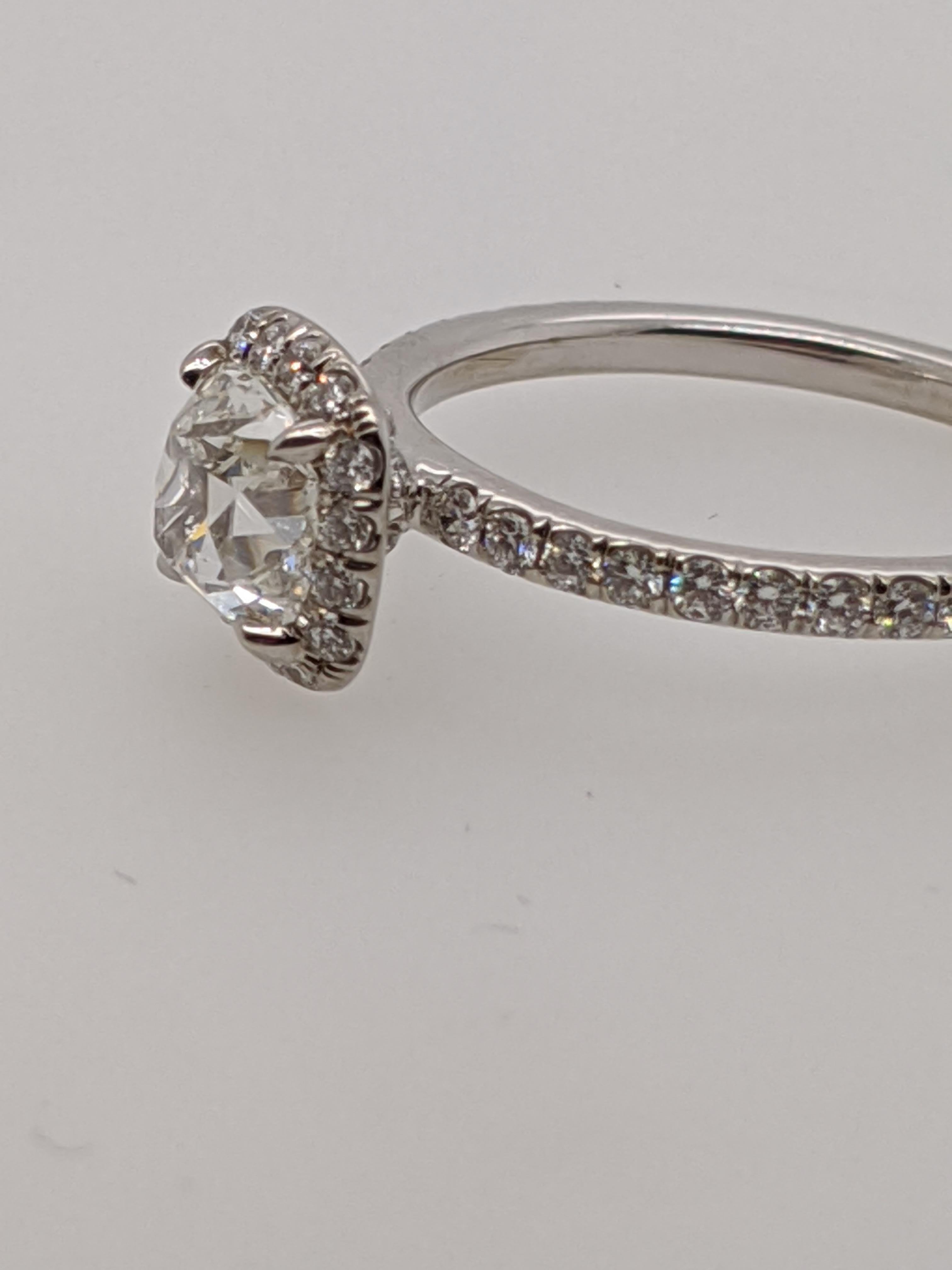 Classic  white halo ring handmade in the United States.  Featuring a one carat or larger antique style cushion cut diamond with GIA grading report. This listing has one of hundreds of cushion cut diamonds in our office and we are happy to create a