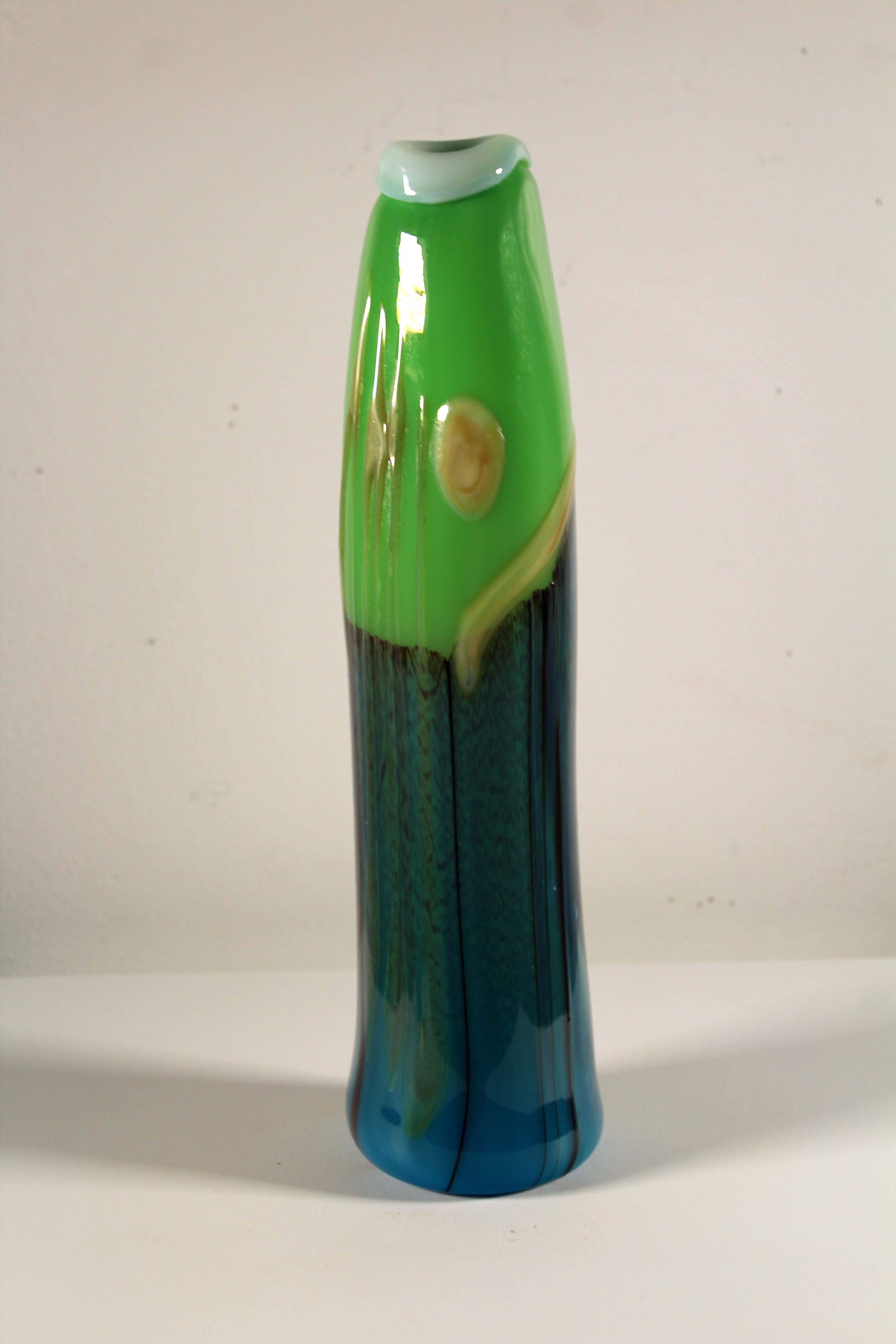 A slender and tall postmodern handblown glass vase by Jack Schmidt. Etched signature on bottom and dated 1975. The vase has a bold lime green and blue palate that adds a punch of color in a modern or contemporary space. From a private collection.