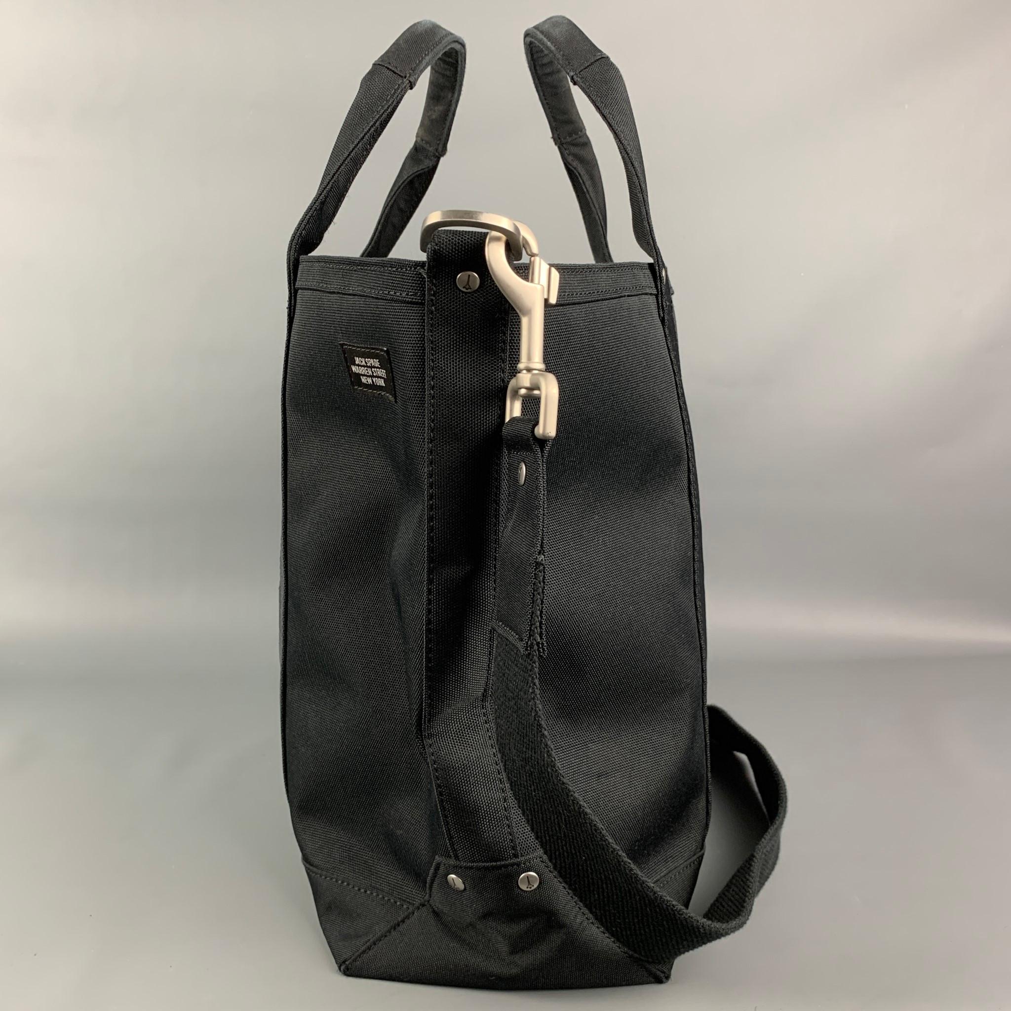 JACK SPADE tote bag comes in a black canvas featuring a tote style, top handles, inner slots, detachable shoulder strap, and a zipper closure. 

Very Good Pre-Owned Condition.

Measurements:

Length: 15 in.
Width: 5.5 in.
Height: 13 in.
Drop: 21 in. 