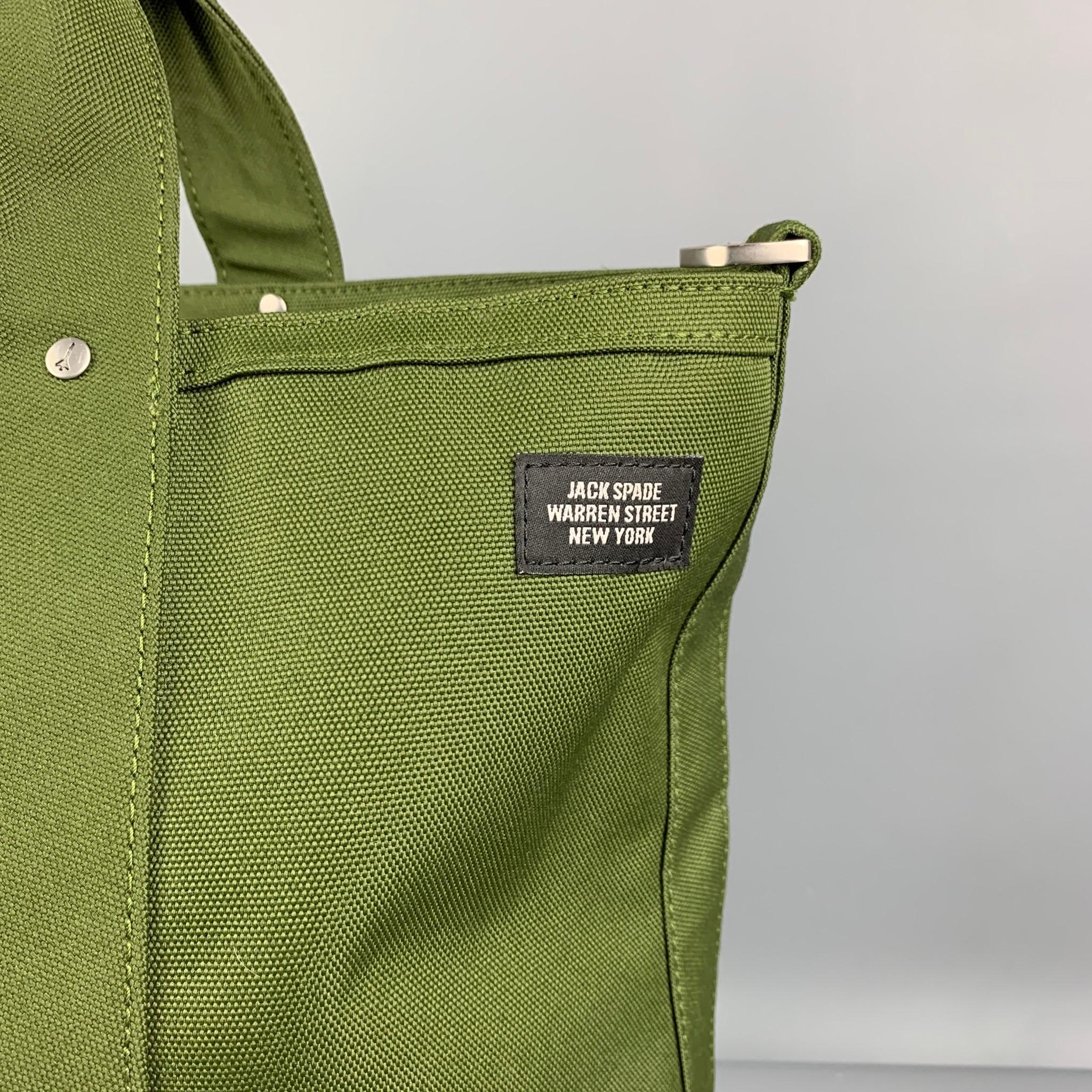 JACK SPADE bag comes in a olive & grey two toned canvas featuring a tote style, top handles, inner slots, and a zip up closure. 

Very Good Pre-Owned Condition. Missing strap. Light marks at bottom.

Measurements:

Length: 15 in.
Width: 6