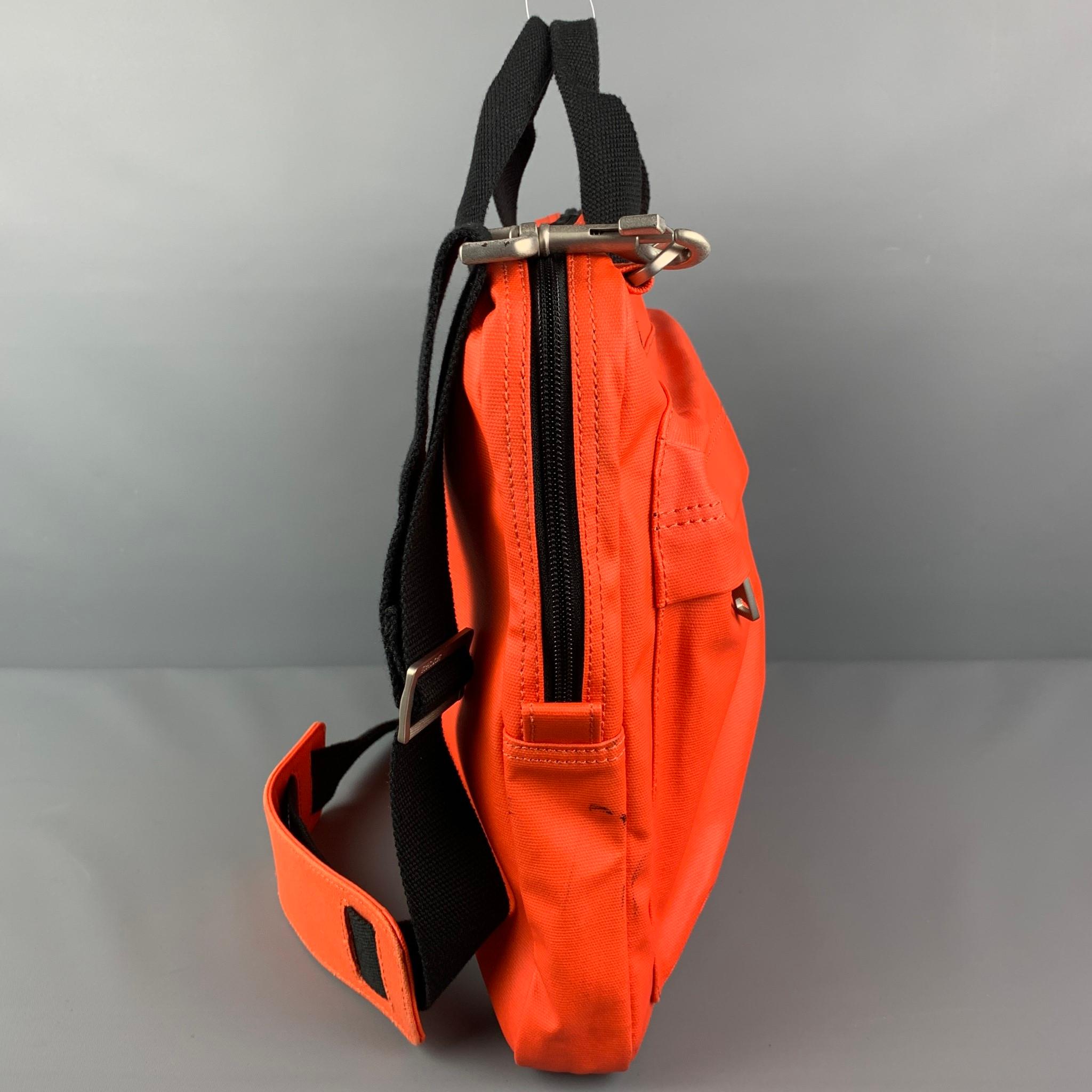 JACK SPADE bag comes in a orange canvas featuring a black detachable cross body strap, top handles, large front pocket, inner slots, zipper closure. 

Good Pre-Owned Condition. Minor marks at back & side of bag.

Measurements:

Length: 15.5