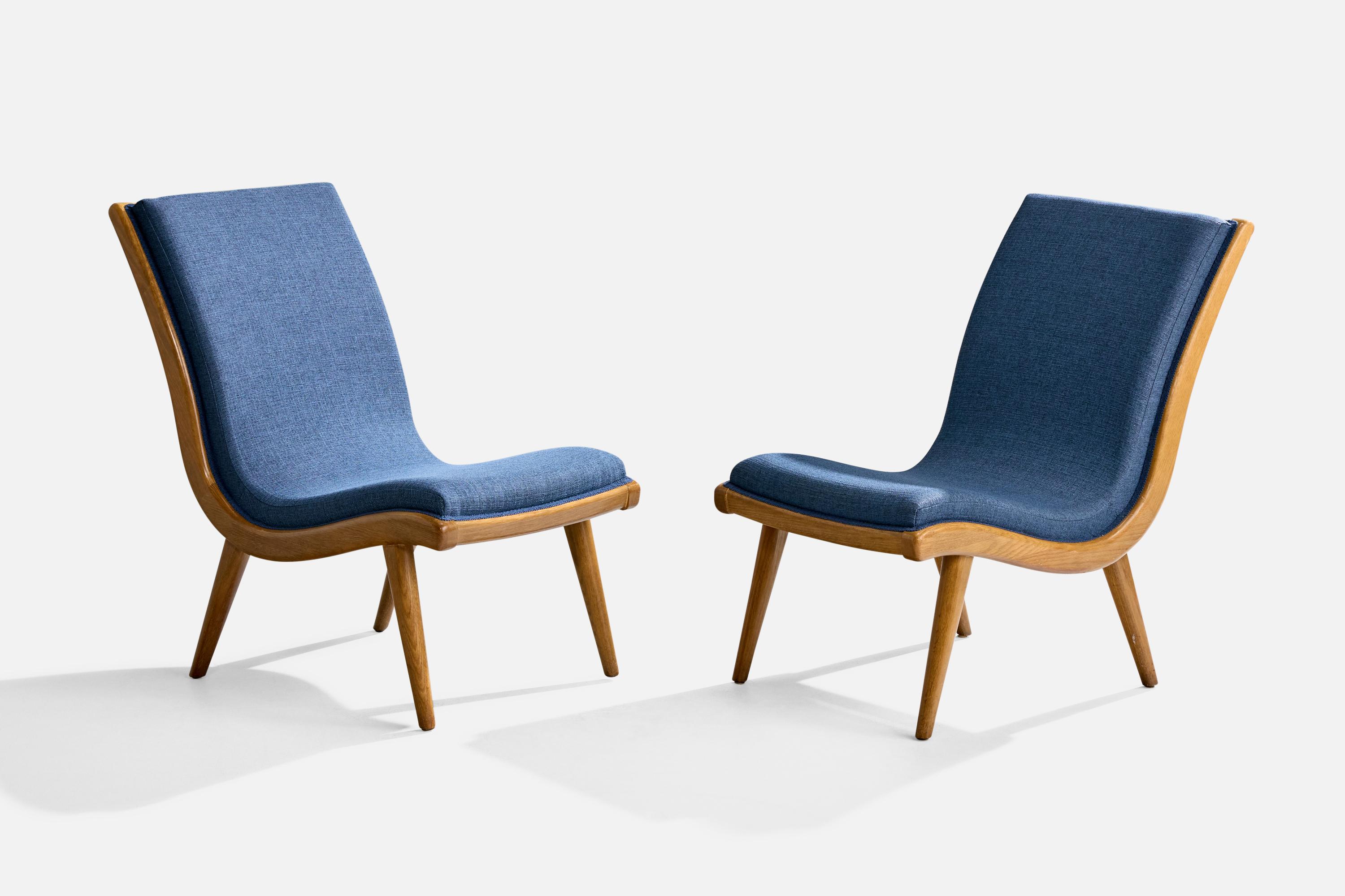 A pair of oak and blue fabric slipper lounge chairs designed by Jack Van der Molen and produced by Jamestown Lounge Company, USA, c. 1950s.

Overall Dimensions (inches): 33.75