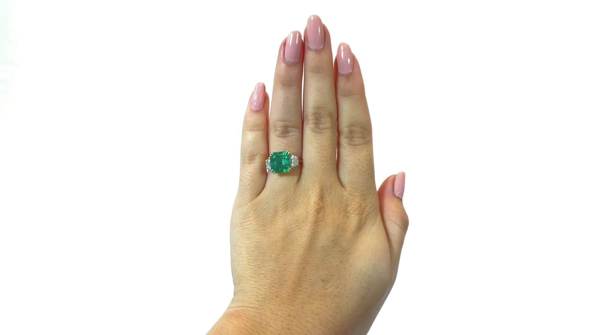 AGL 3.48 Carat Emerald Diamond Platinum & Yellow Gold Ring. Featuring a 3.48 carat emerald that is certified by AGL as Colombian with minor traditional oil. Accented by 2 trapezoid cut diamonds weighing  approximately 0.52 carats F-G color, VS