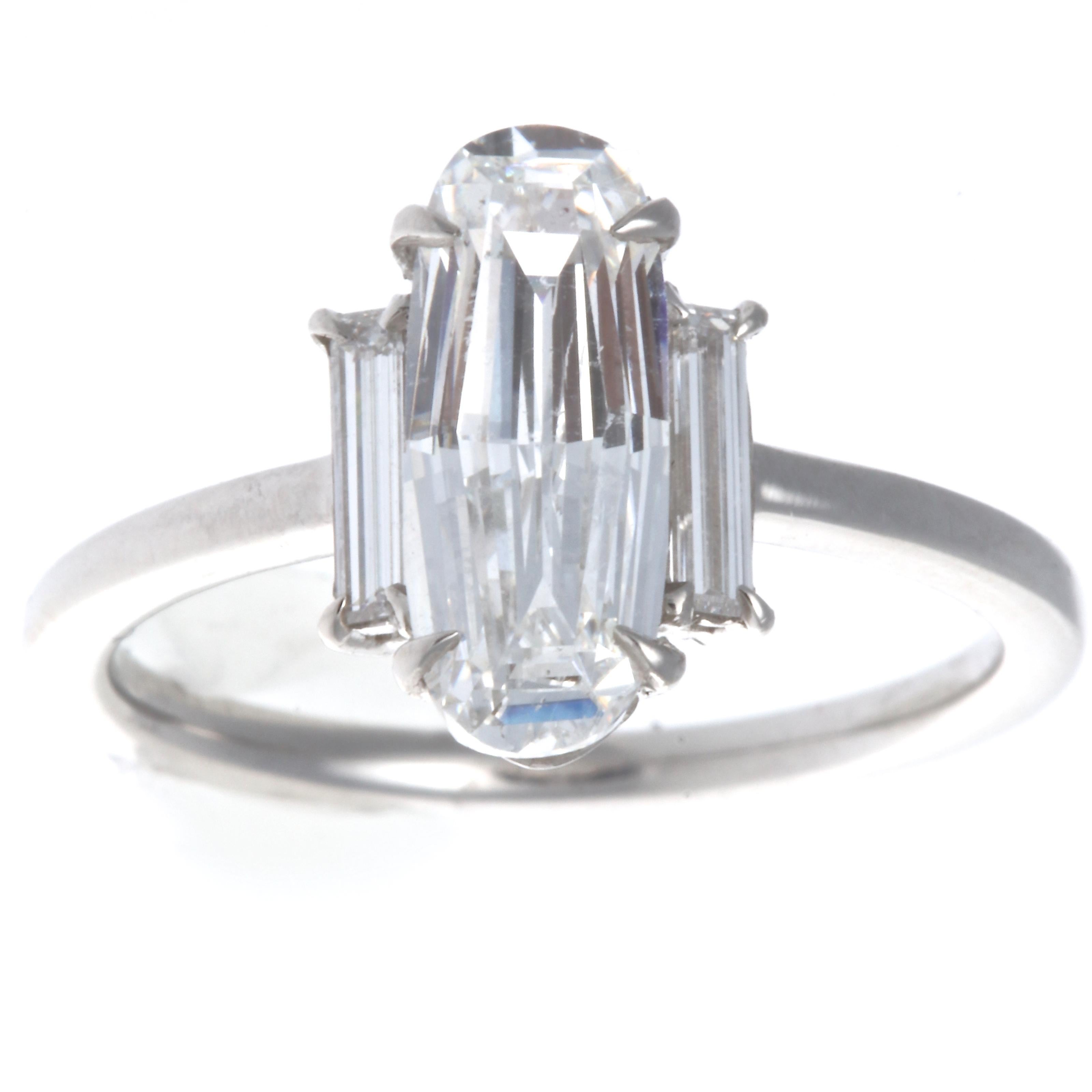 A unique old step cut that brings out the life and sparkle of the diamond. GIA 1.59 carat old step cut, F color SI1 clarity diamond platinum engagement ring. Accented by 2 two baguette cut diamonds weighing approximately  0.30 carats, E-F VVS. Ring
