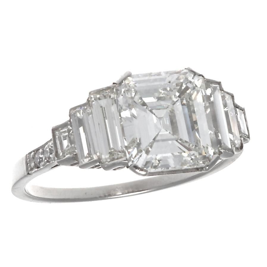 Cut to perfect proportions this GIA certified 2.02 carat, I color VS 1 clarity emerald cut diamond is a show stopper. Beautifully paired with 6 baguette cut diamonds that are bezel set and 2 round cut diamonds. There is a seamless purity to the ring