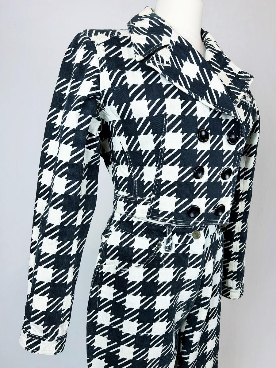 Spring-Summer 1991
France

Iconic jacket and trousers from the famous Tati collection by Azzedine Alaïa. Black Vichy cotton twill canvas with large houndstooth motifs. High-waisted outfit with a fitted jacket, large folded collar and double-breasted
