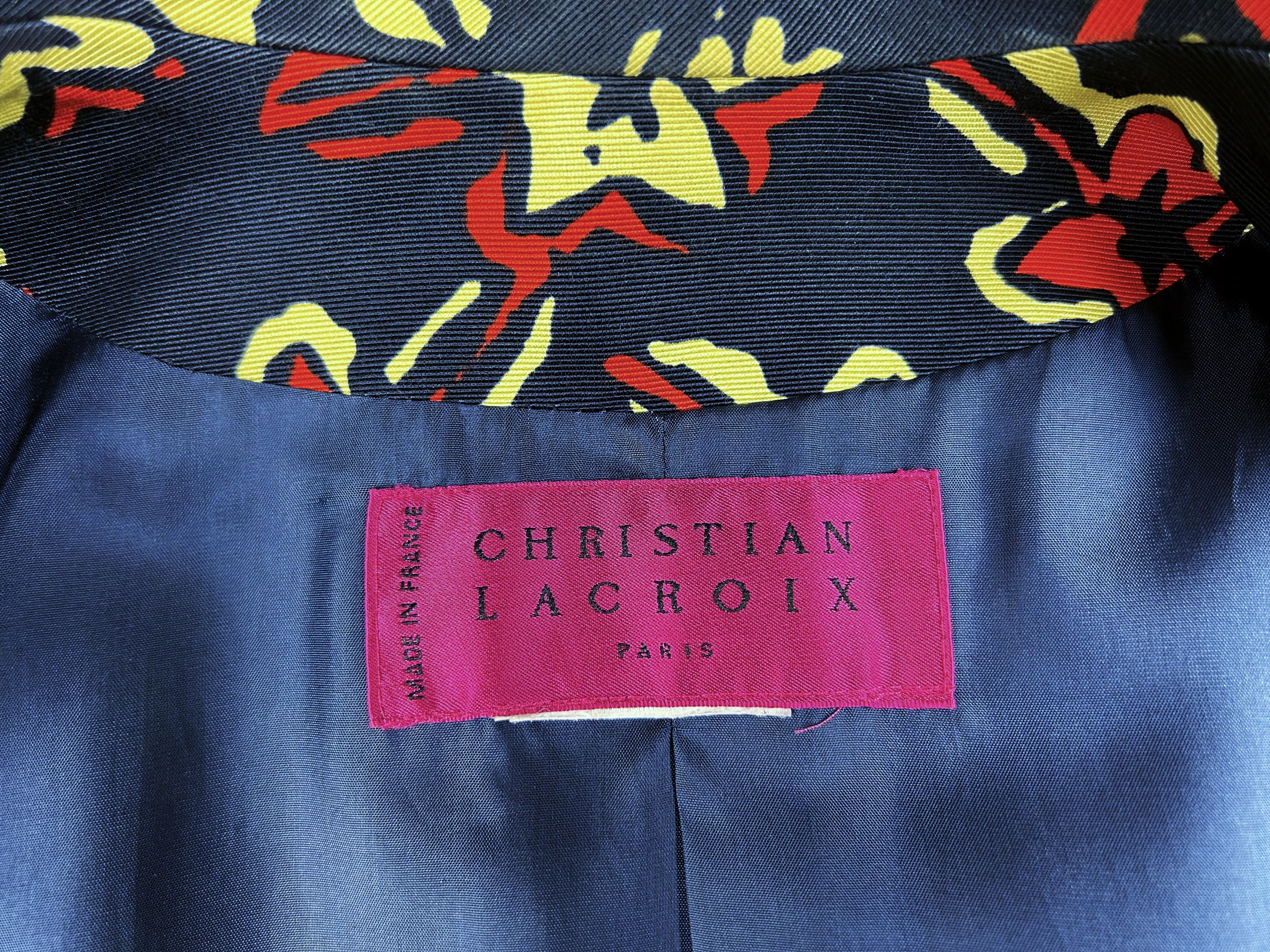 Circa 2000

France

Beautiful fluted silk faille jacket by Christian Lacroix dating from 2000. Fitted, shouldered jacket with fold-down collar and large navy blue and red button fastening at the front and echo at the cuffs. Printed silk ottoman with