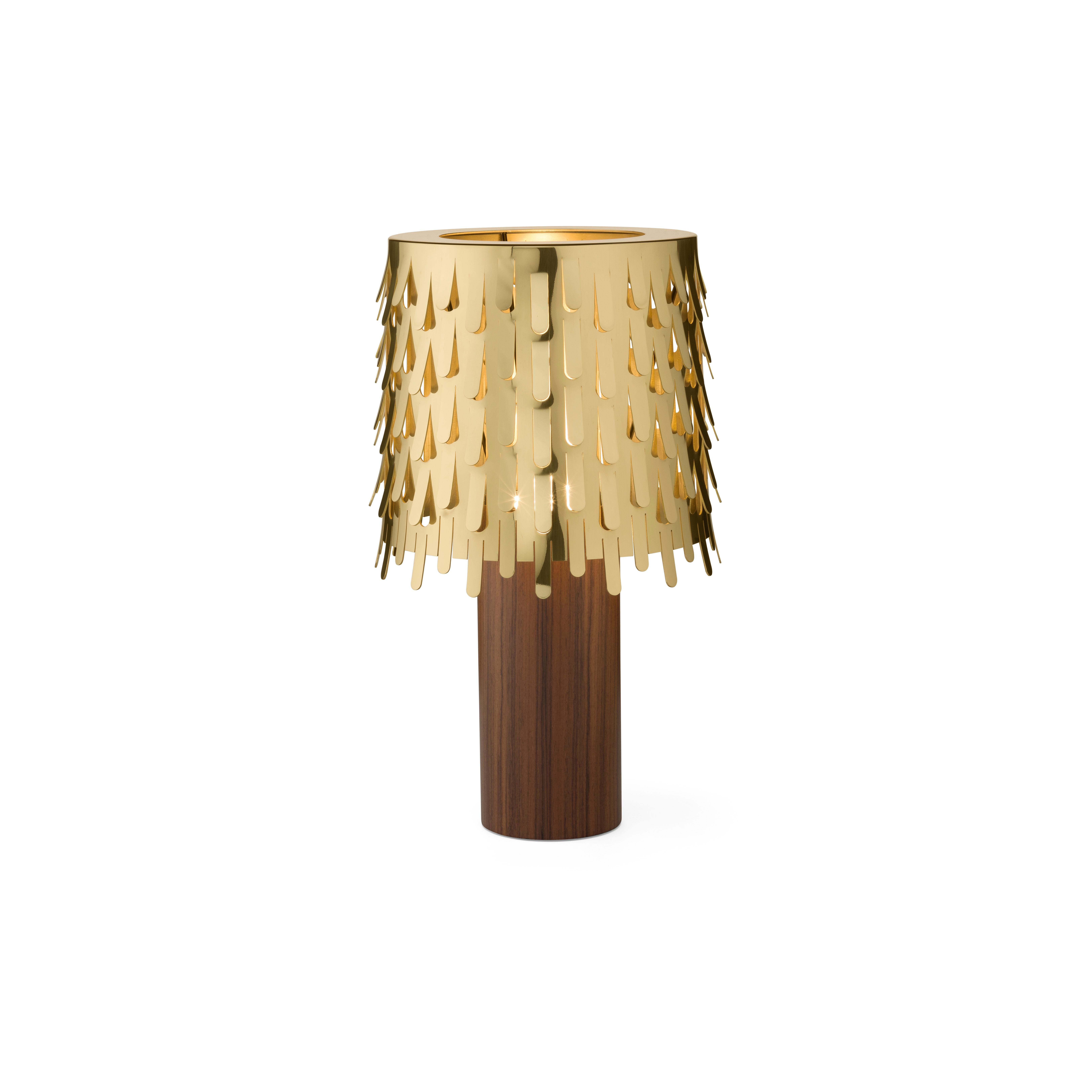 Jackfruit table lamp by campana brothers. The lamp is made of polished brass, synonymous of elegance and preciousness. It is composed of two overlapping cylinders, the large stem supports an important lampshade decorated with a thousand leaves bent