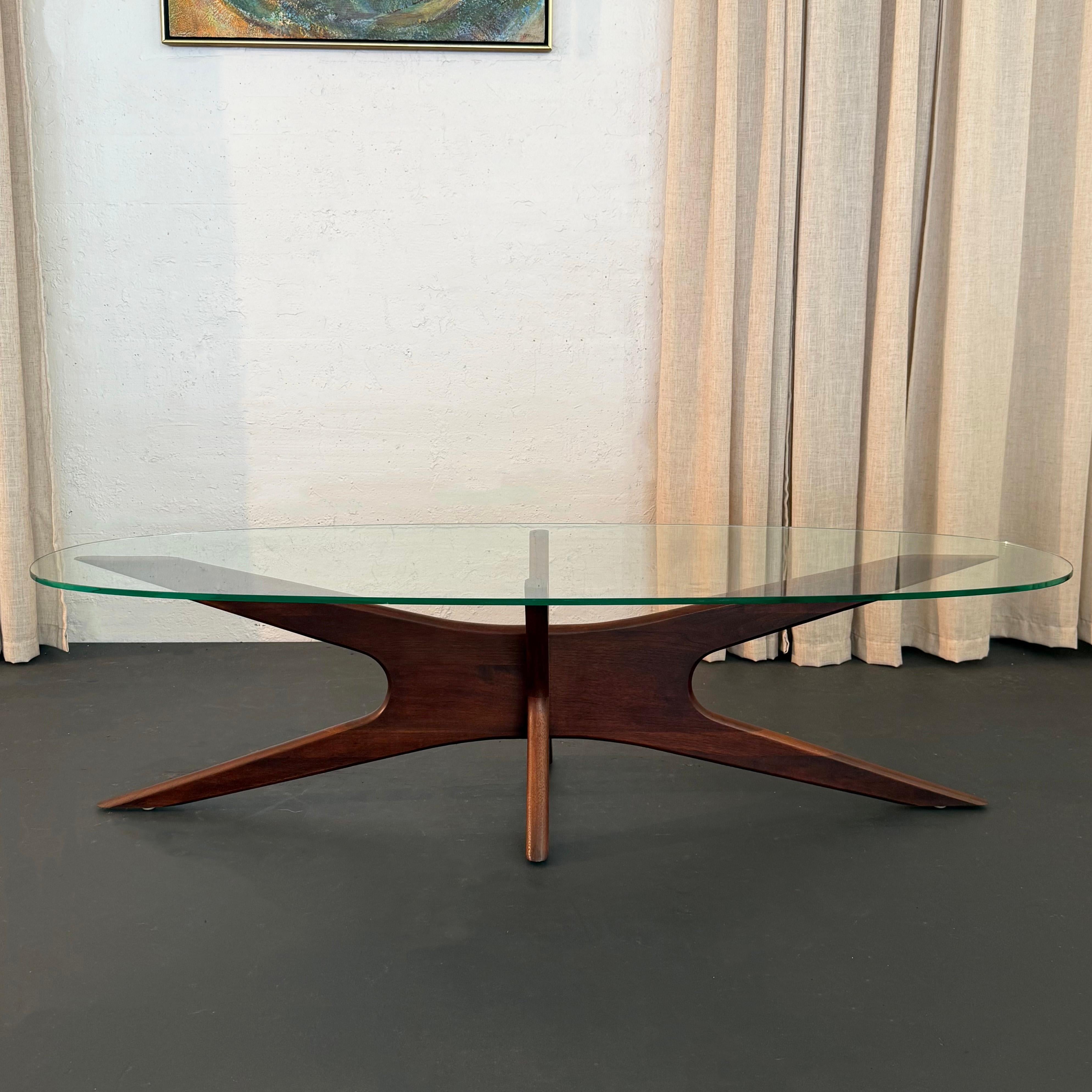 This Mid-Century Modern, glass and walnut, model 893-TGO, coffee table known as the 