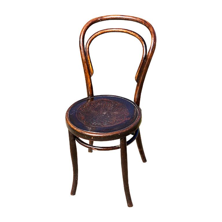 A rare pair of Jacob & Josef Kohn or Mazowia Bentwood side chairs. Created from wood, this duo features a fabulous pressed shell motif on the seat, and a lovely double bentwood back. The chairs have round seats and stand upon four splayed legs. Each