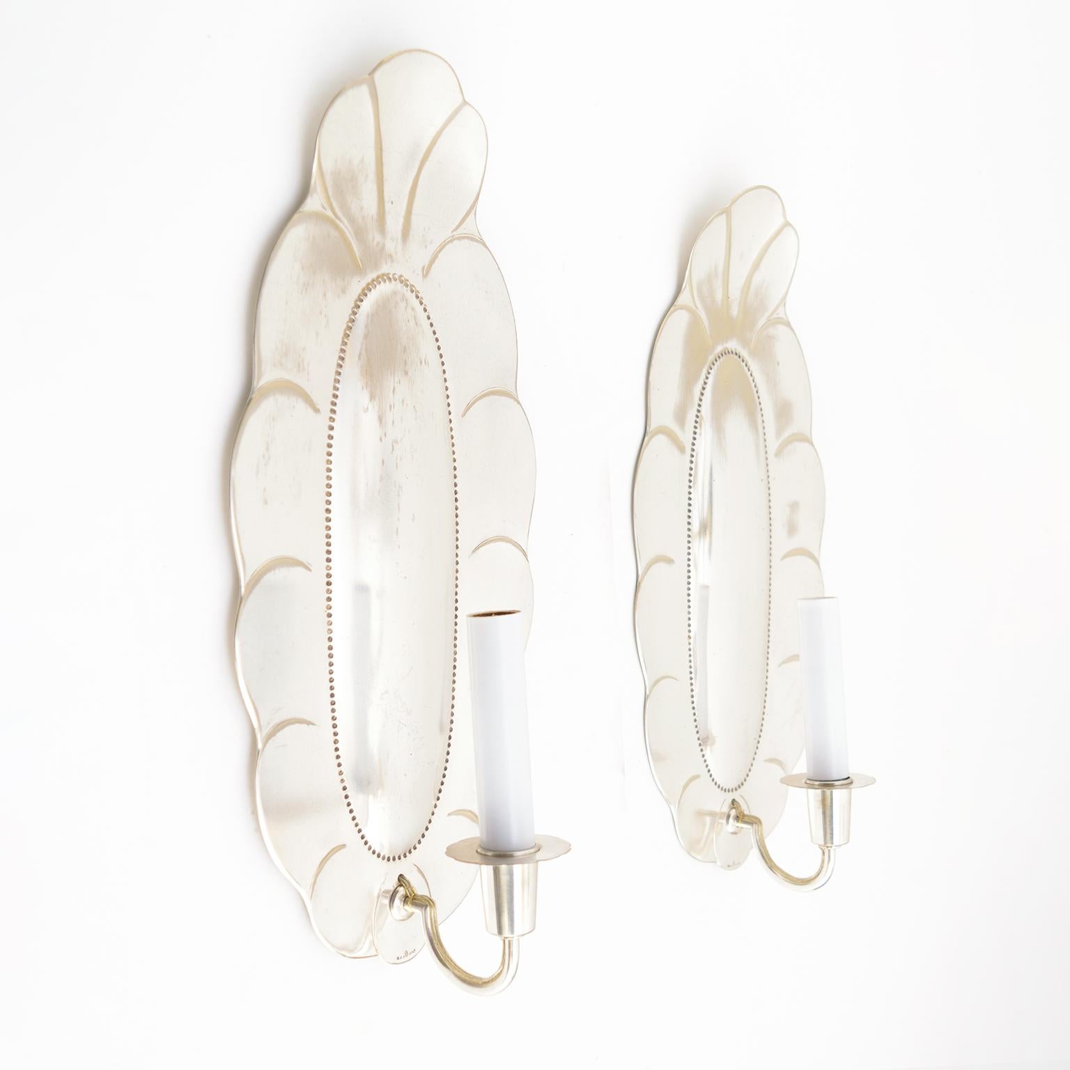 Large pair of Swedish art deco silver plated sconces from Jacob Ängman for GAB, Stockholm. The sconces have been newly polished, lacquered and electrified with candelabra sockets. Light wear to backplates with silver loss. 

Measures: Height 15