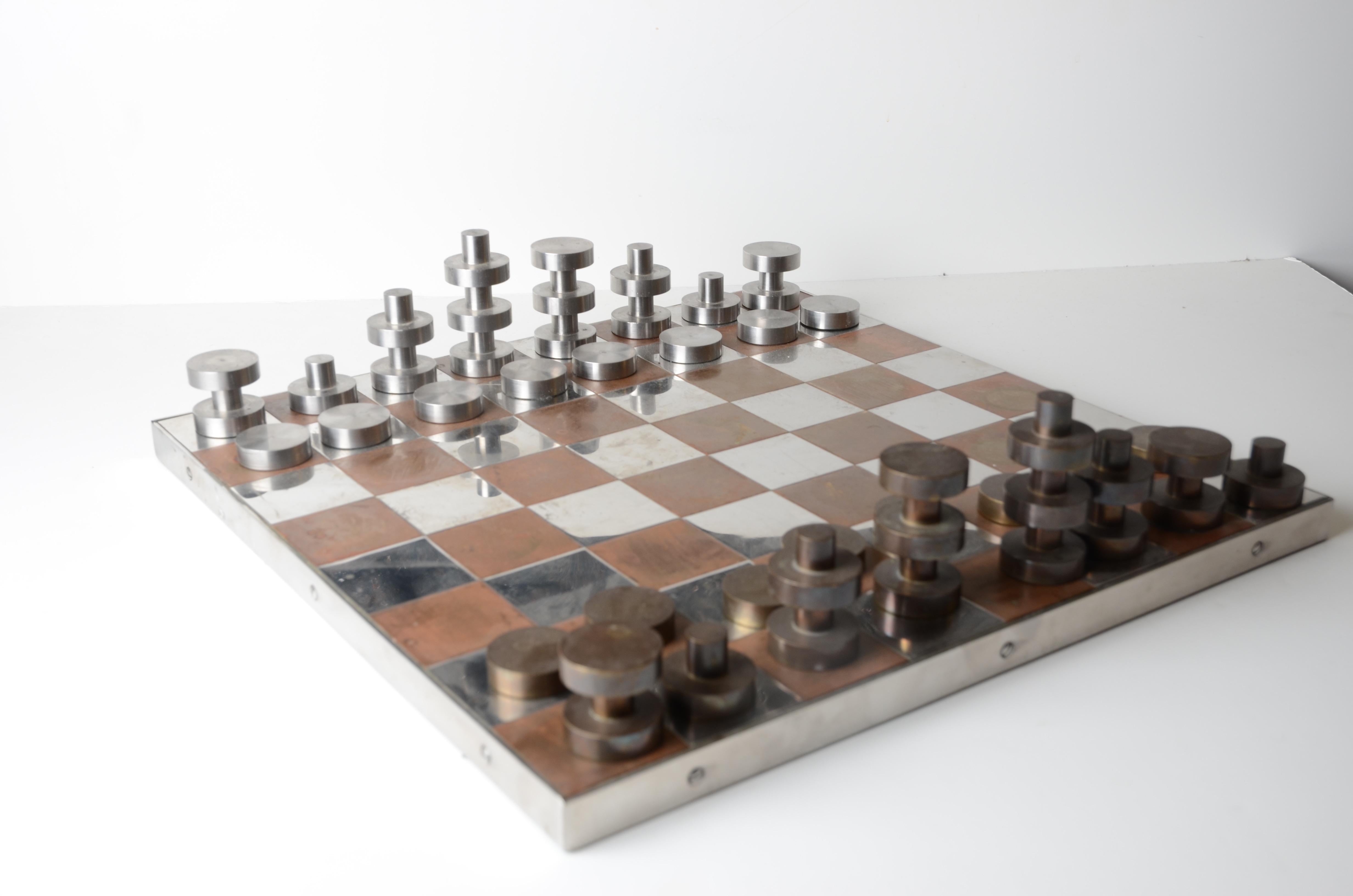 A chess set in brass and stainless steel, designed by Jacob Asbaek. Denmark, 1970s.